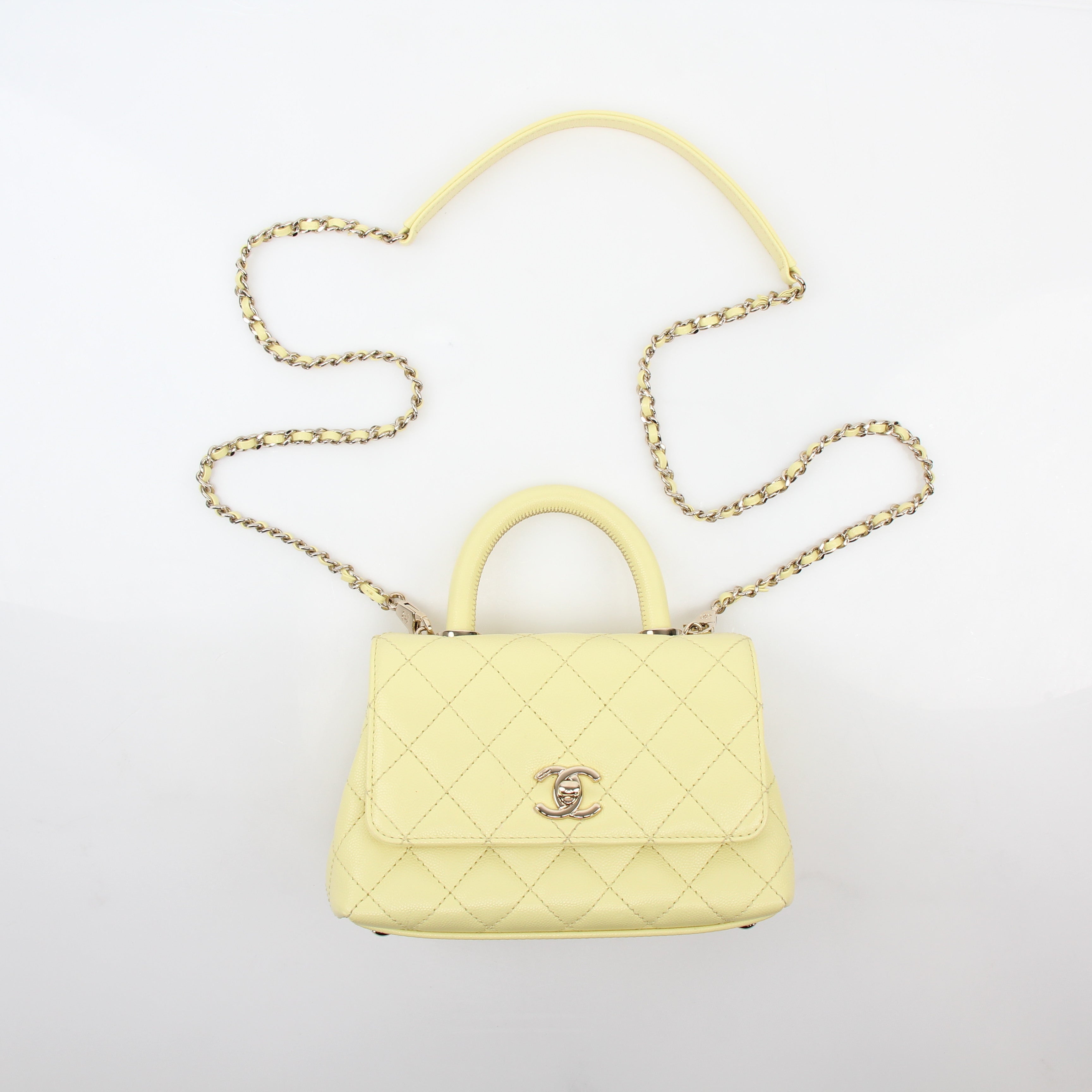 Yellow Chanel Mini Coco Handle Flap Bag handbag with gold hardware and classic quilted design.