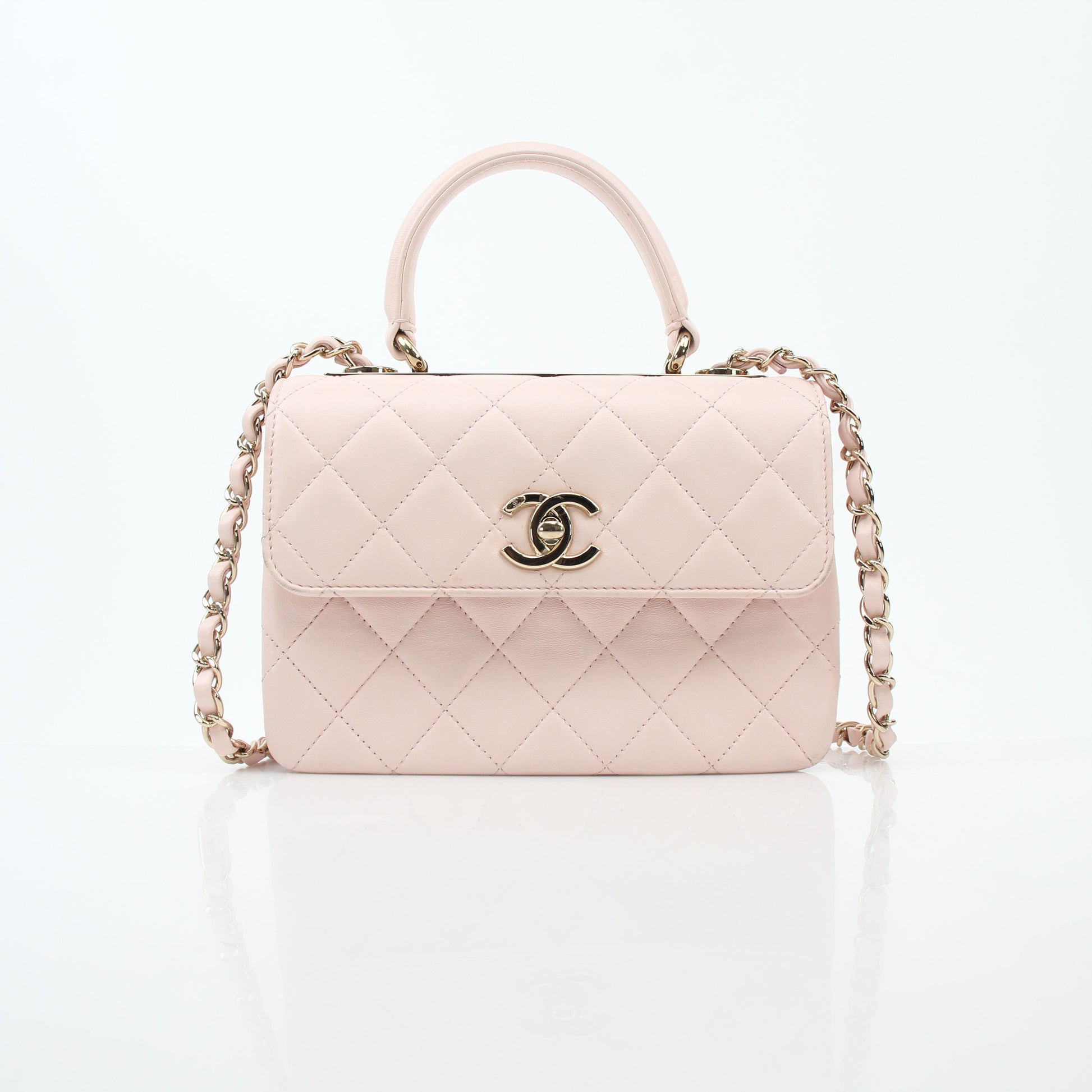 Pink Chanel small CC flap handbag with top handle, trendy designer purse by Gold & Beyond, featuring gold hardware and quilted leather.