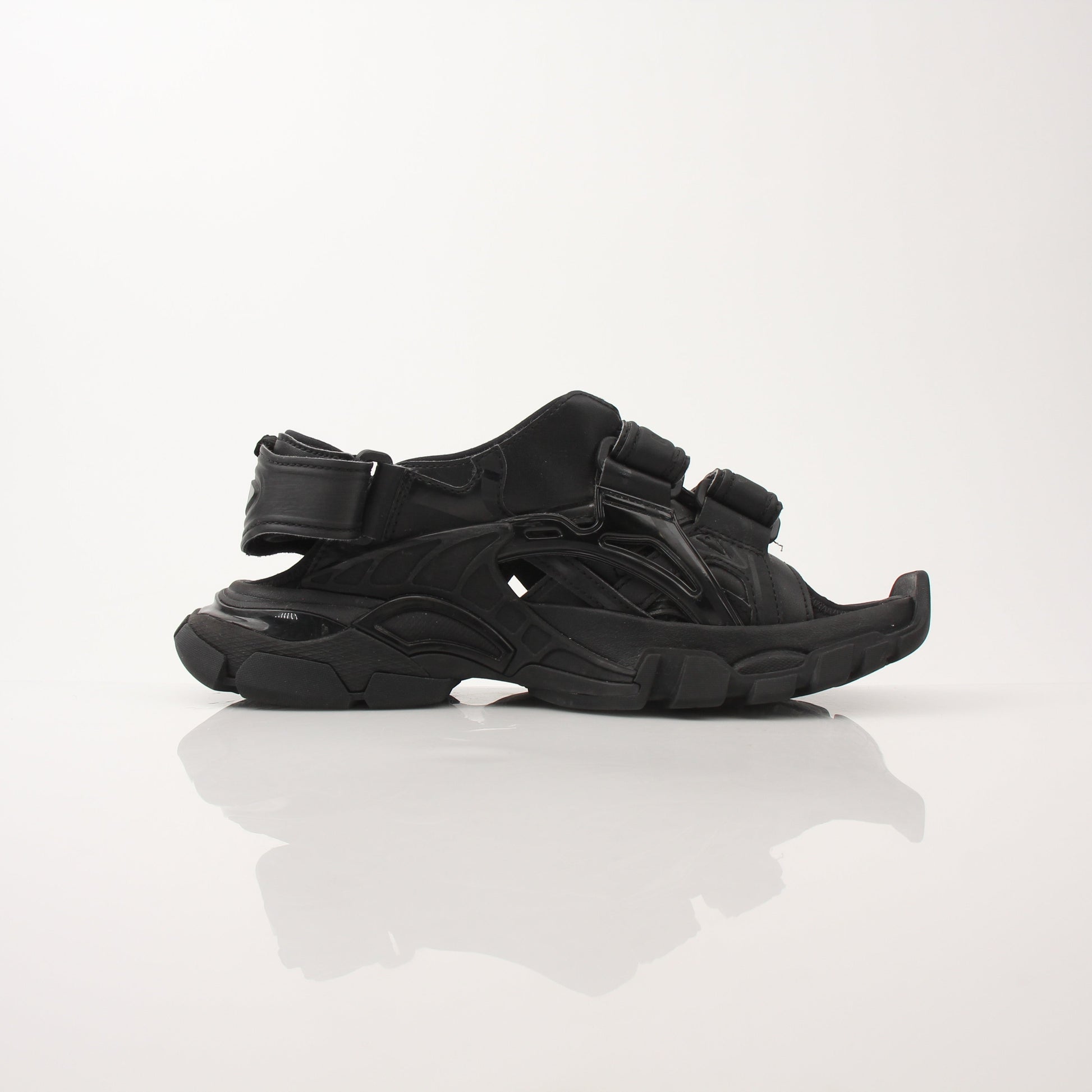 Balenciaga women's track sandals in black with sporty design and chunky sole, displayed on a neutral background.