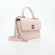 Gold & Beyond pink Chanel small CC flap handbag with top handle, trendy handbag with gold accents and quilted design.
