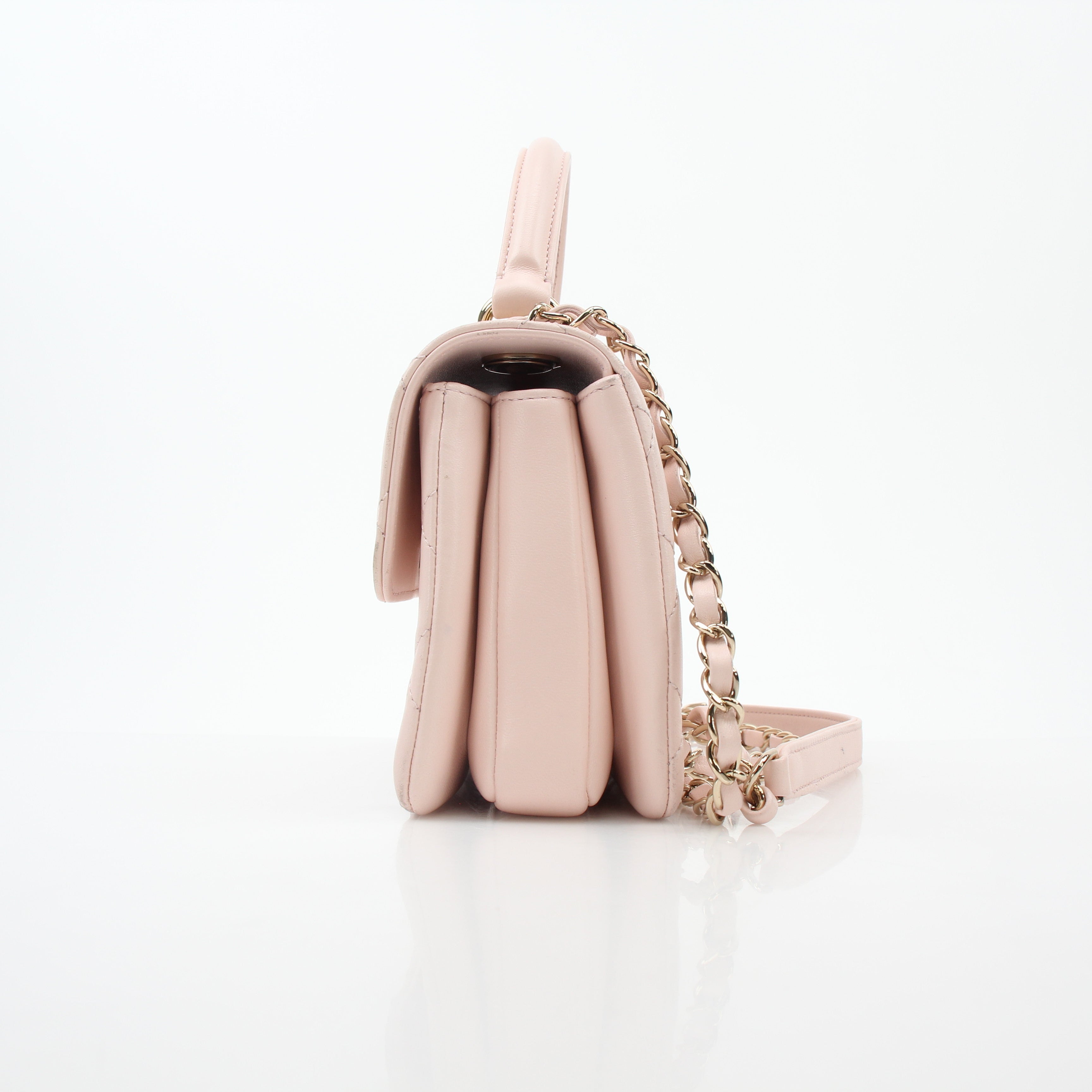 Gold & Beyond Chanel pink small CC flap handbag with top handle, trendy designer handbag with gold hardware and flap closure.