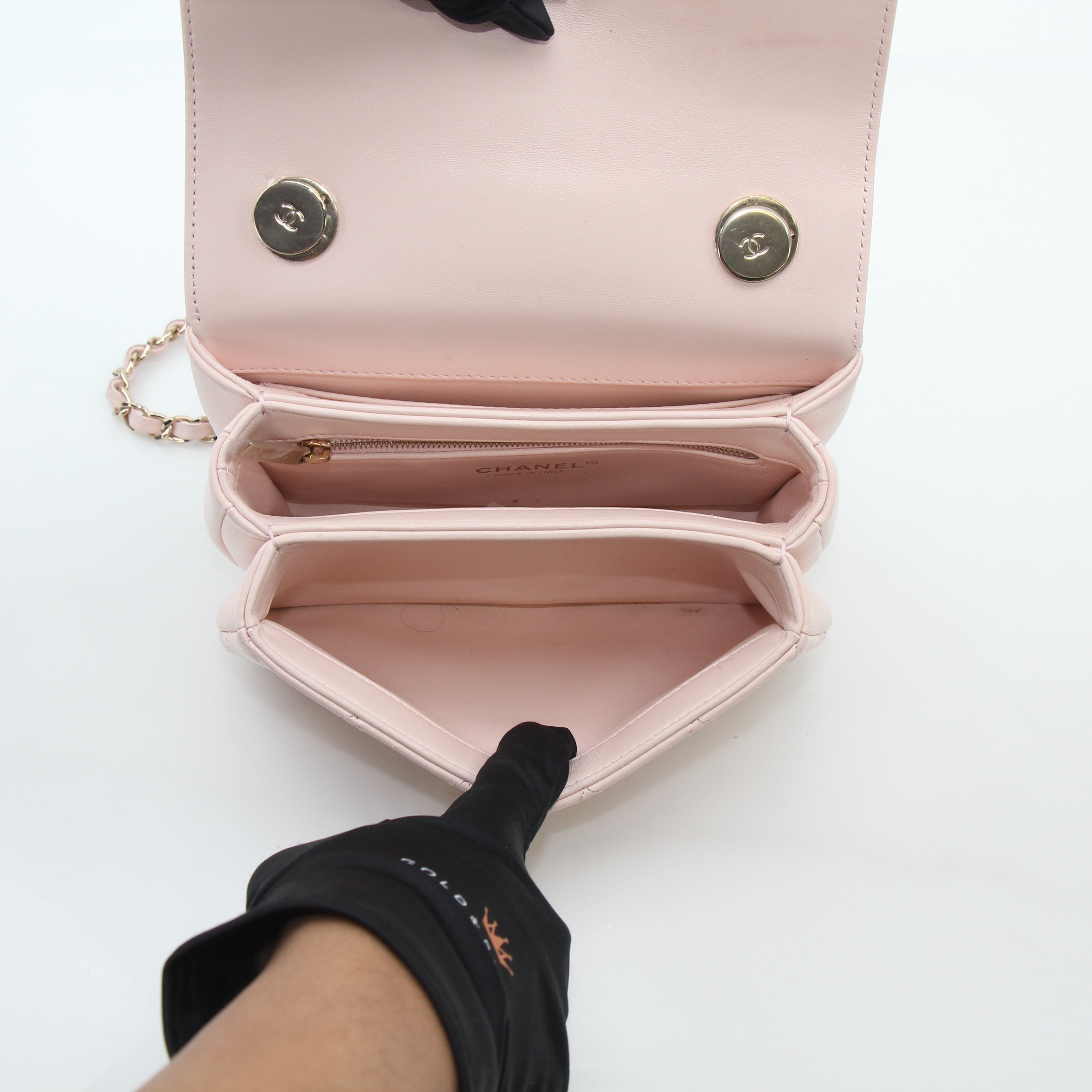 Pink Chanel small CC flap handbag with top handle, trendy designer handbag with gold accents and compact style.