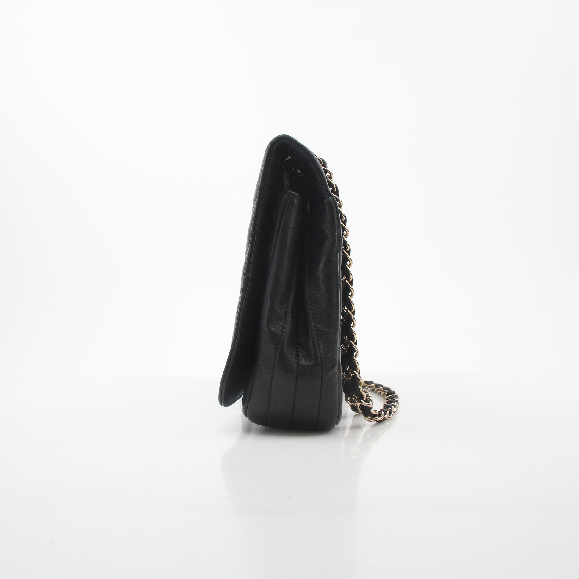 Chanel black chevron flap handbag with gold accents and quilted design, stylish accessory for any outfit.