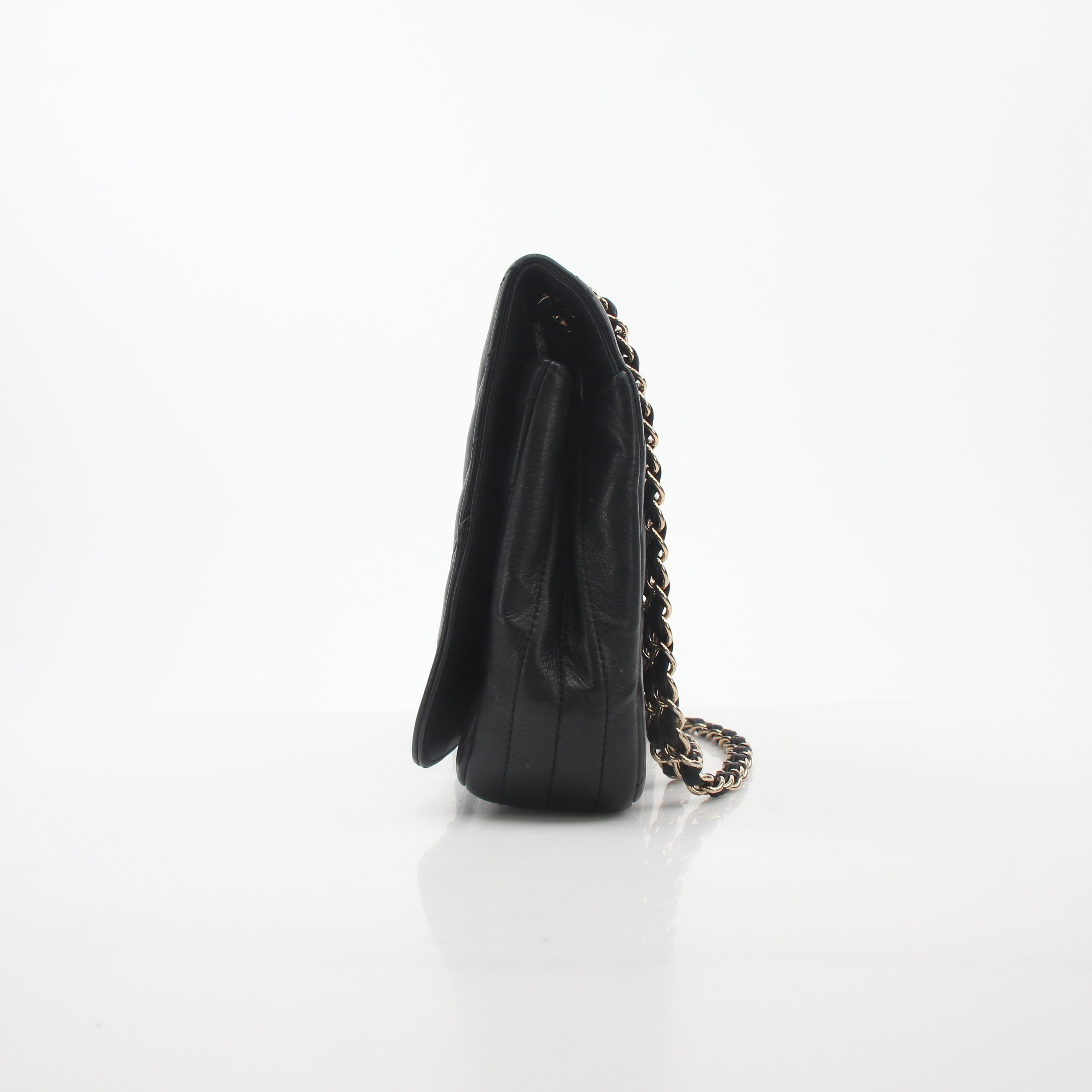 Chanel black chevron flap handbag with gold accents and quilted design, stylish accessory for any outfit.
