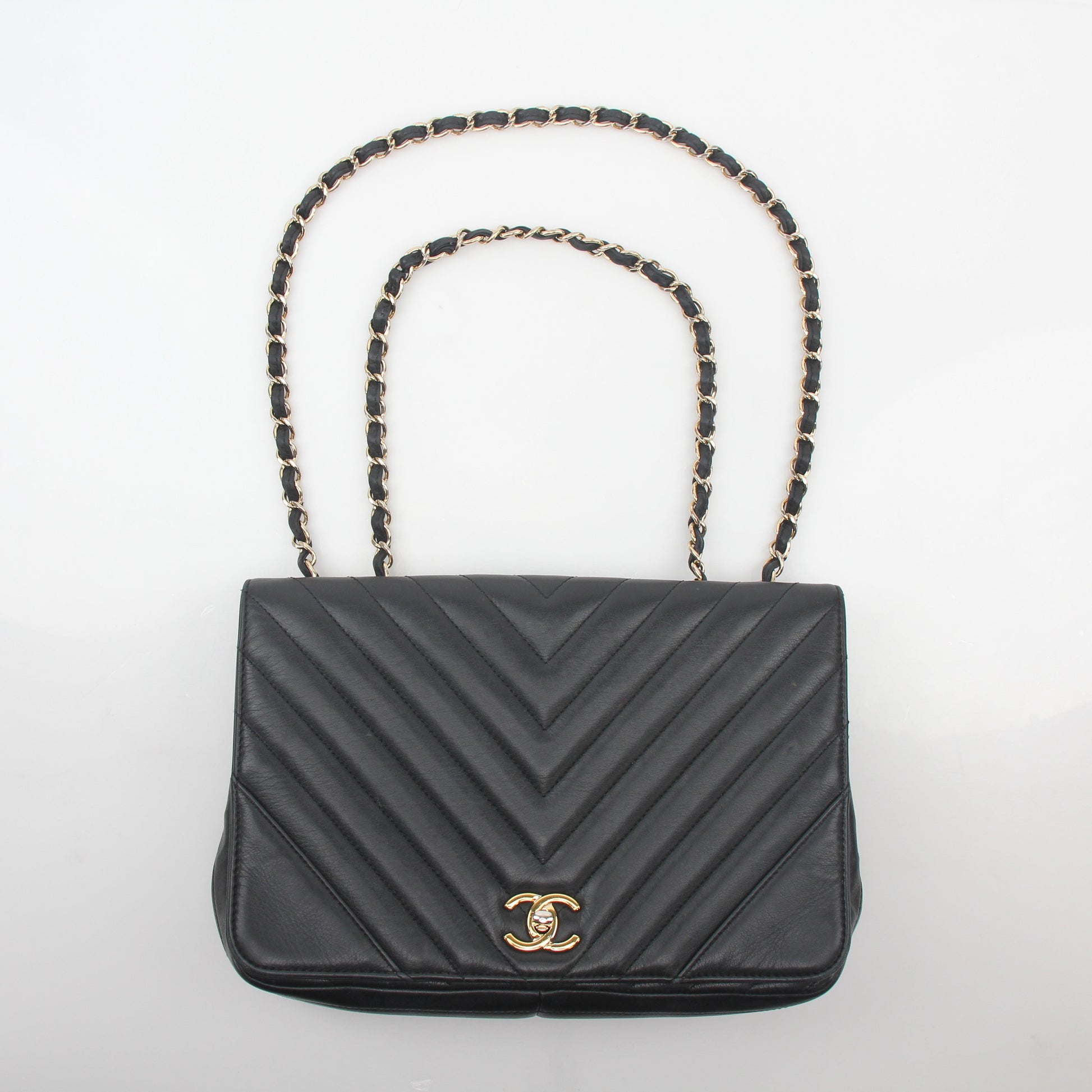 Gold & Beyond Chanel Black Chevron Statement Flap Handbag with gold hardware and signature quilted design.