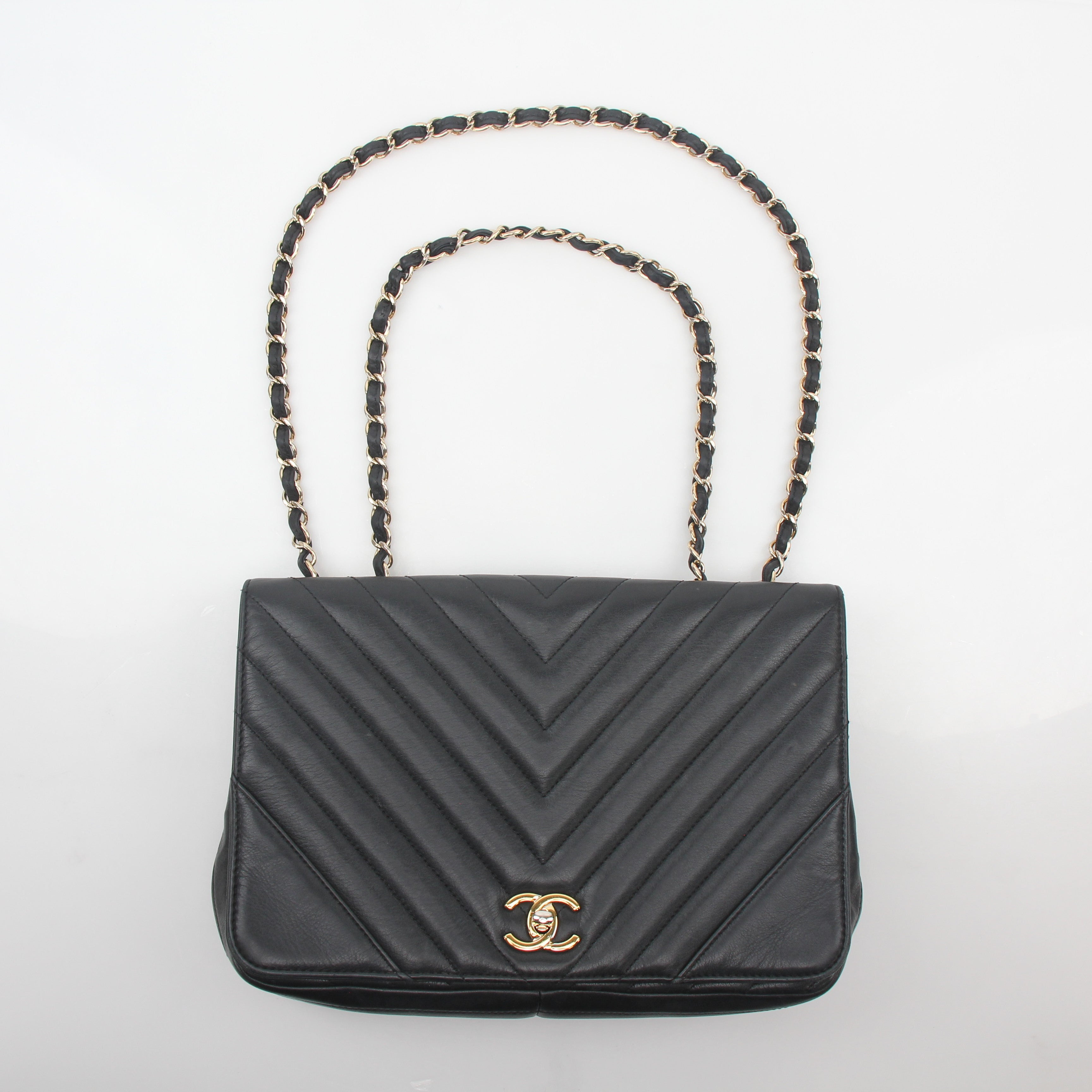 Gold & Beyond Chanel Black Chevron Statement Flap Handbag with gold hardware and signature quilted design.