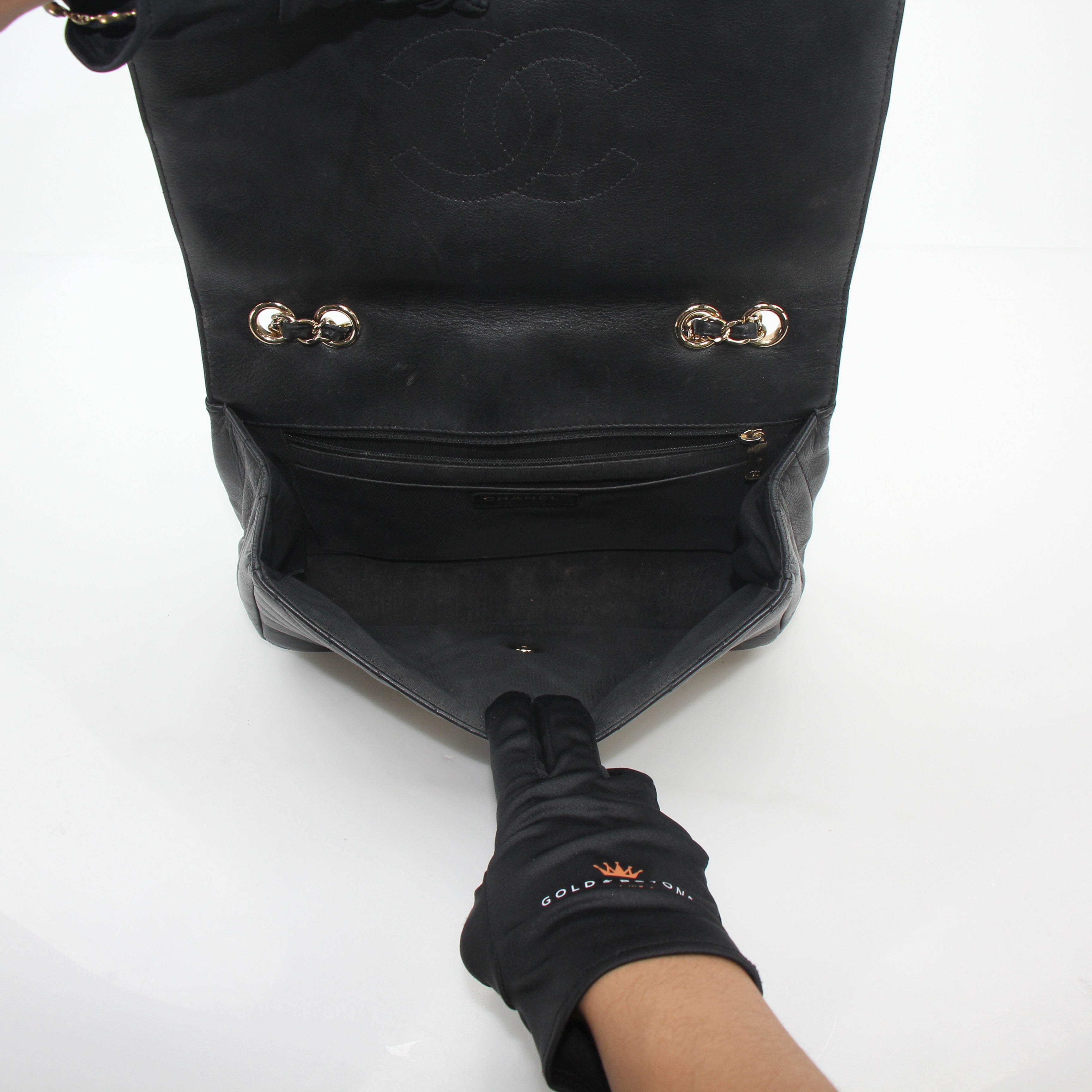 Chanel black chevron flap handbag with gold chain strap and logo clasp, stylish designer handbag by Gold & Beyond