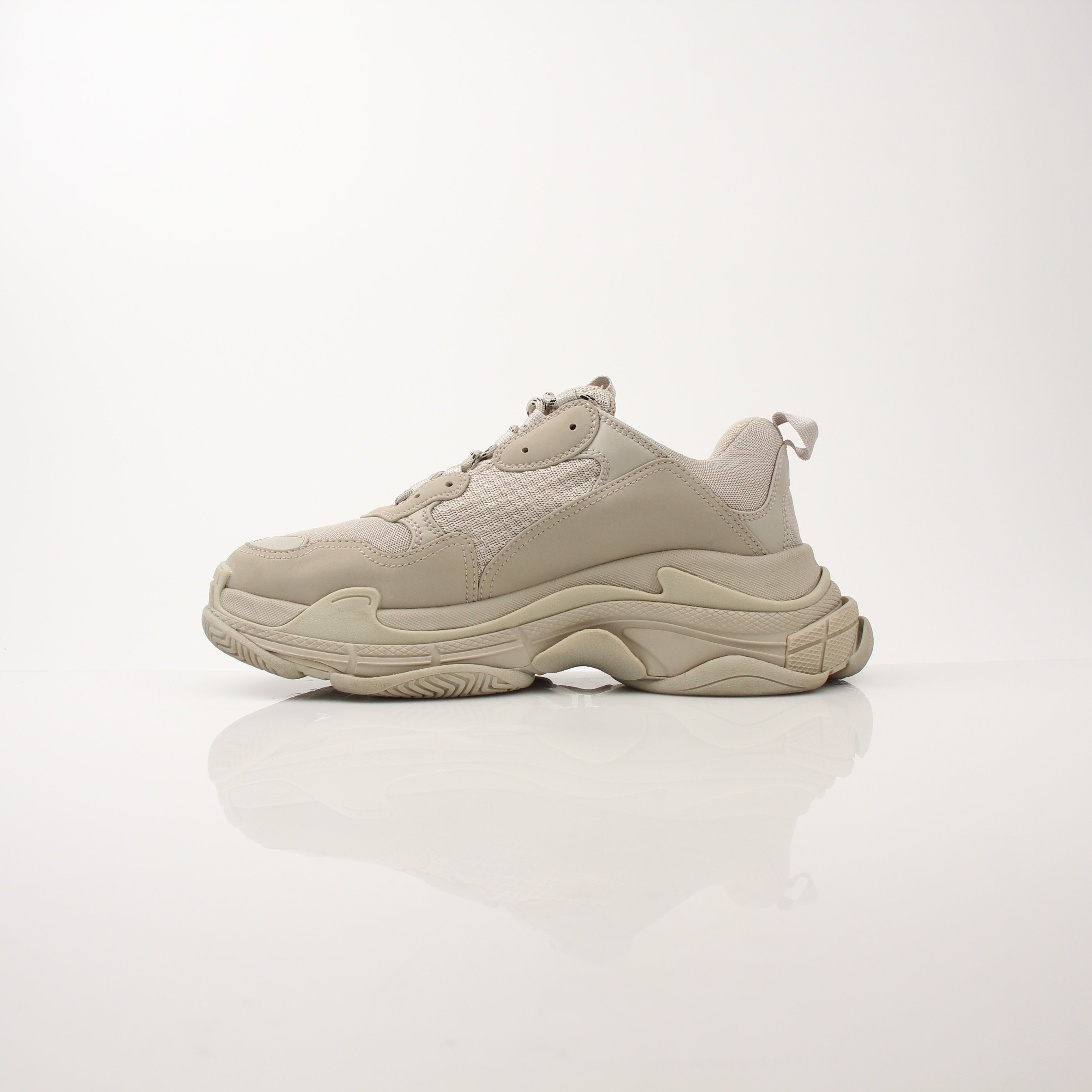 Gold & Beyond men's Balenciaga Triple S sneakers featuring chunky design, white and beige colorway, and textured sole.