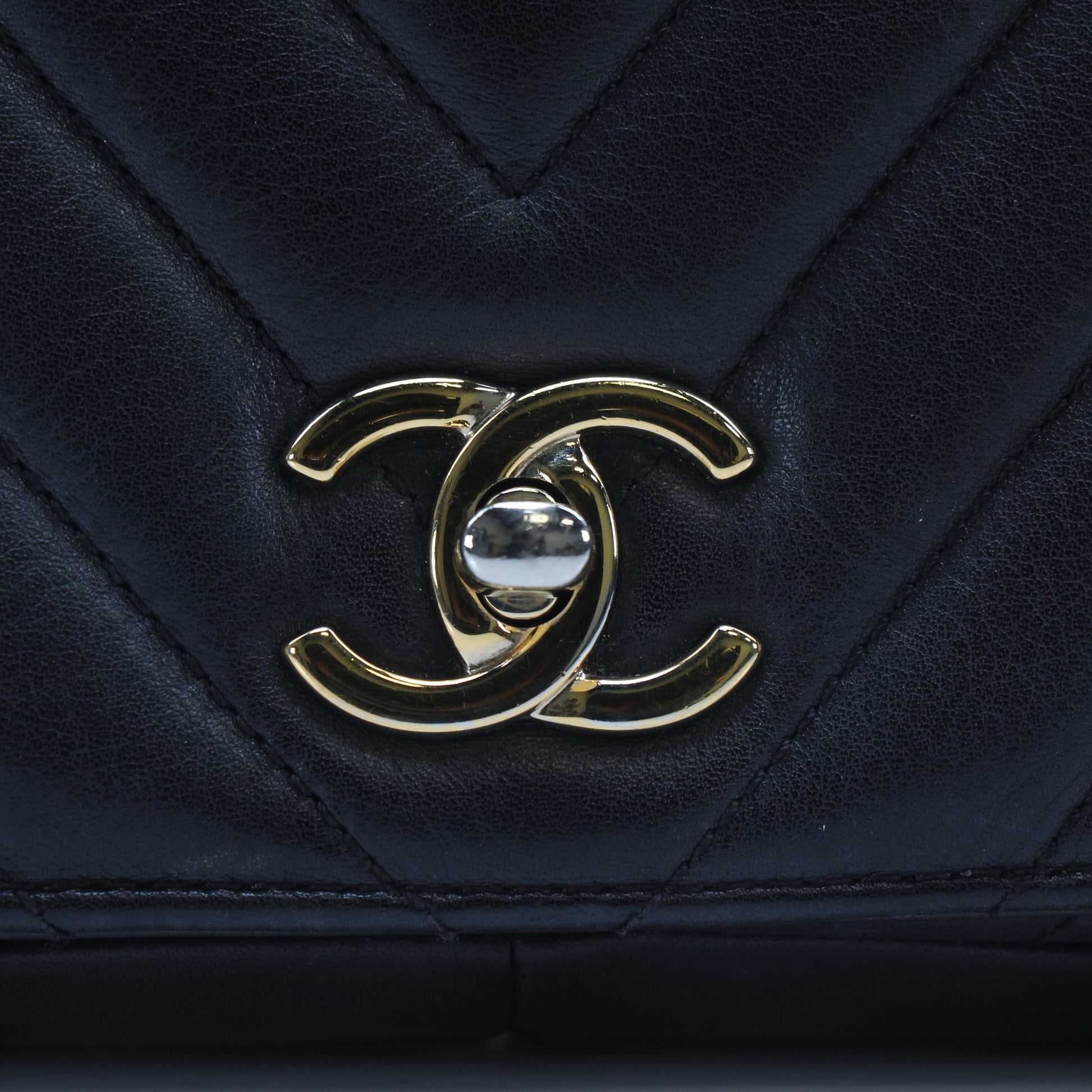 Chanel black chevron statement flap handbag with gold chain strap and quilted leather detailing.