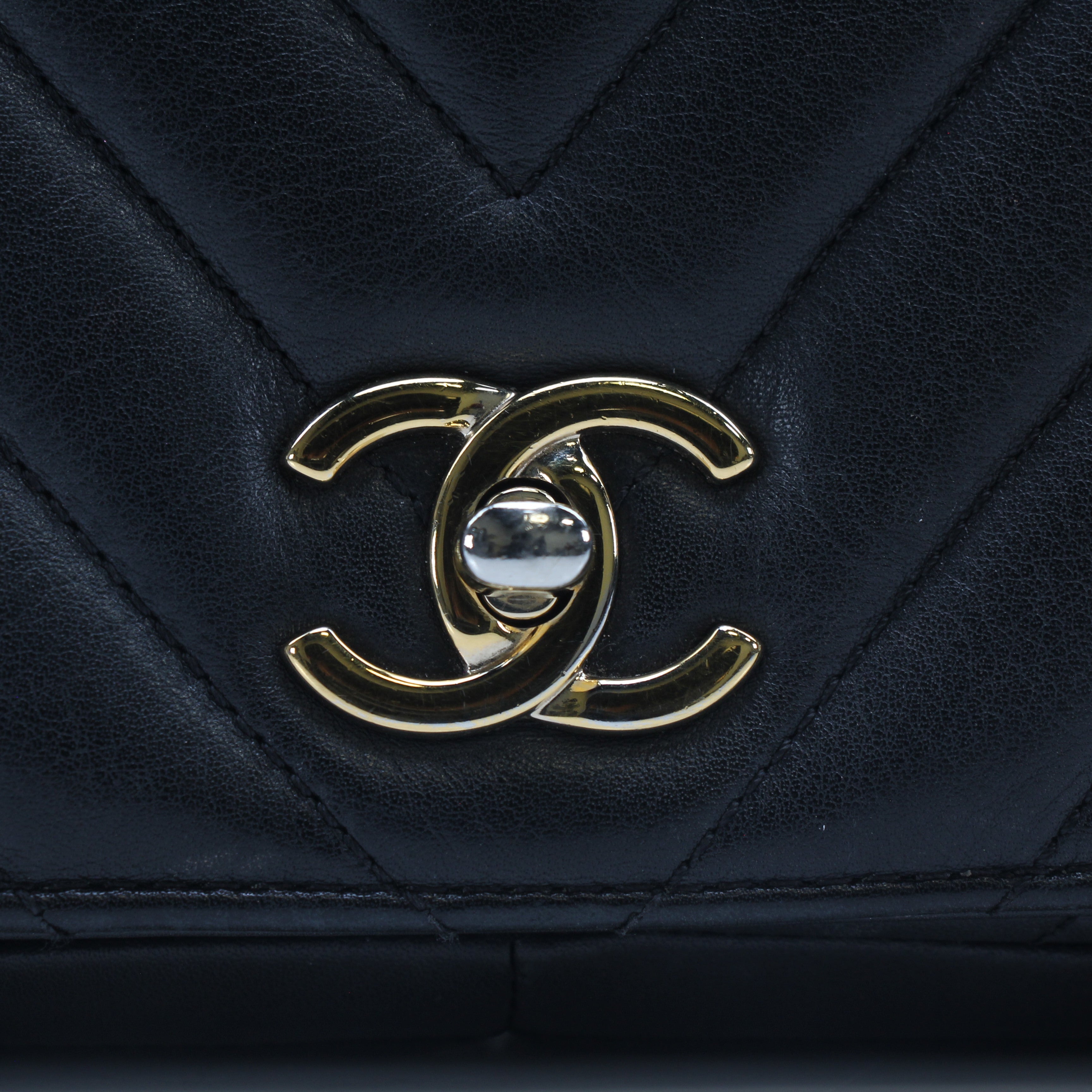 Chanel black chevron statement flap handbag with gold chain strap and quilted leather detailing.