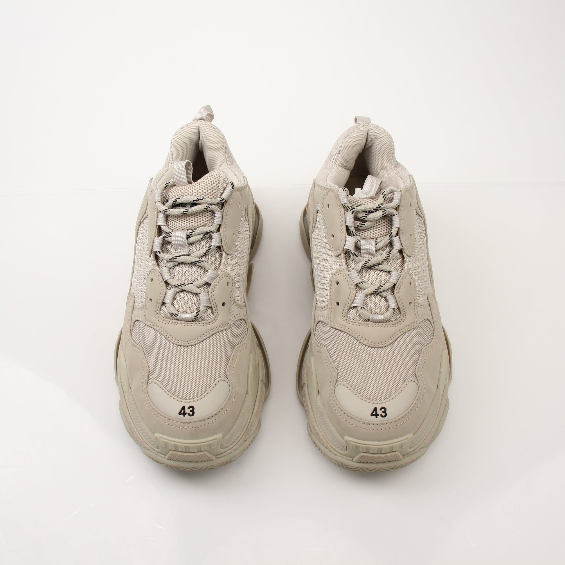 Gold & Beyond men's Balenciaga Triple S sneakers with chunky design, white and beige color, and textured sole.