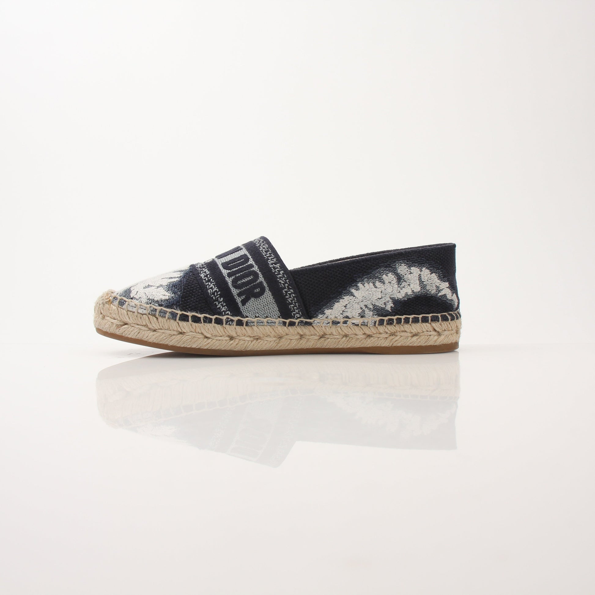 Christian Dior women's Granville tie-dye espadrille flats with woven jute soles and colorful fabric uppers.