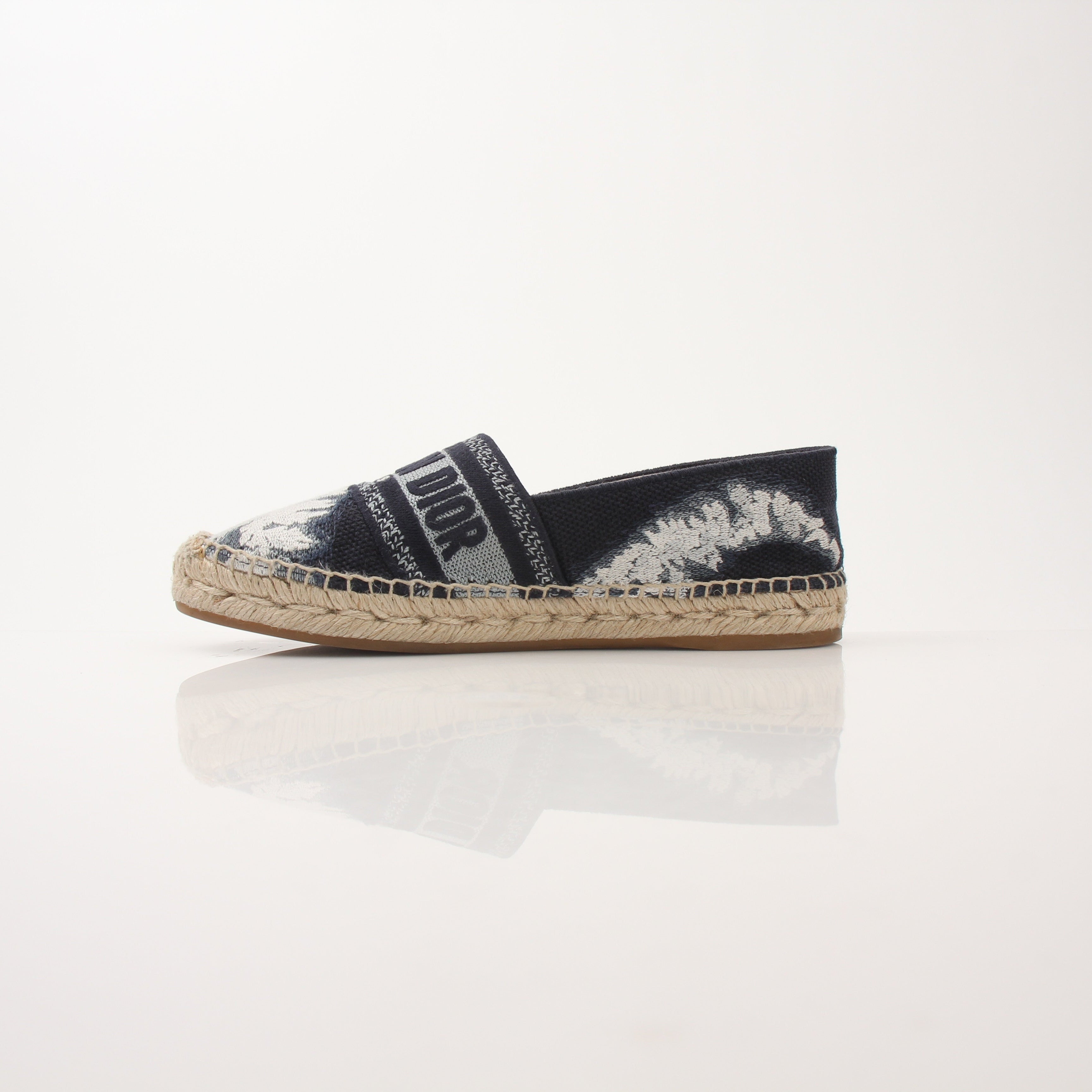 Christian Dior women's Granville tie-dye espadrille flats with woven jute soles and colorful fabric uppers.