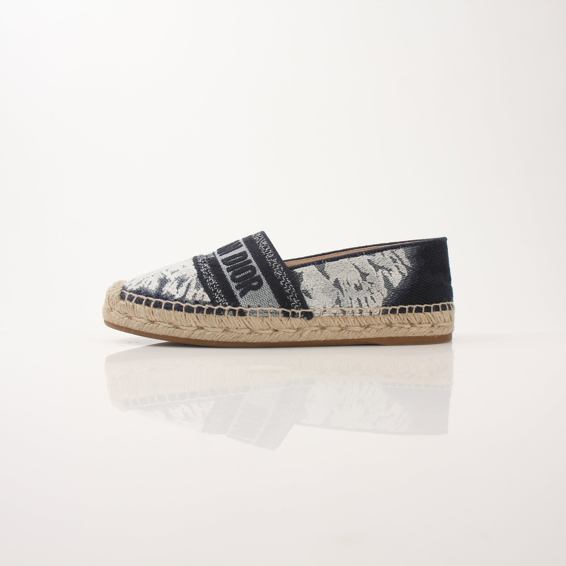 Christian Dior women's Granville tie-dye espadrille flats with woven sole and colorful fabric upper, stylish and comfortable shoes.