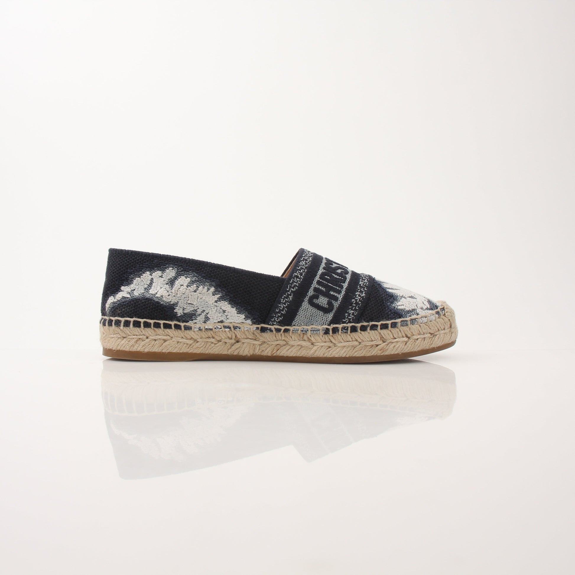 Christian Dior Women’s Granville Tie Dye Espadrille Flats shoes with woven fabric and rubber soles, featuring colorful tie dye pattern.