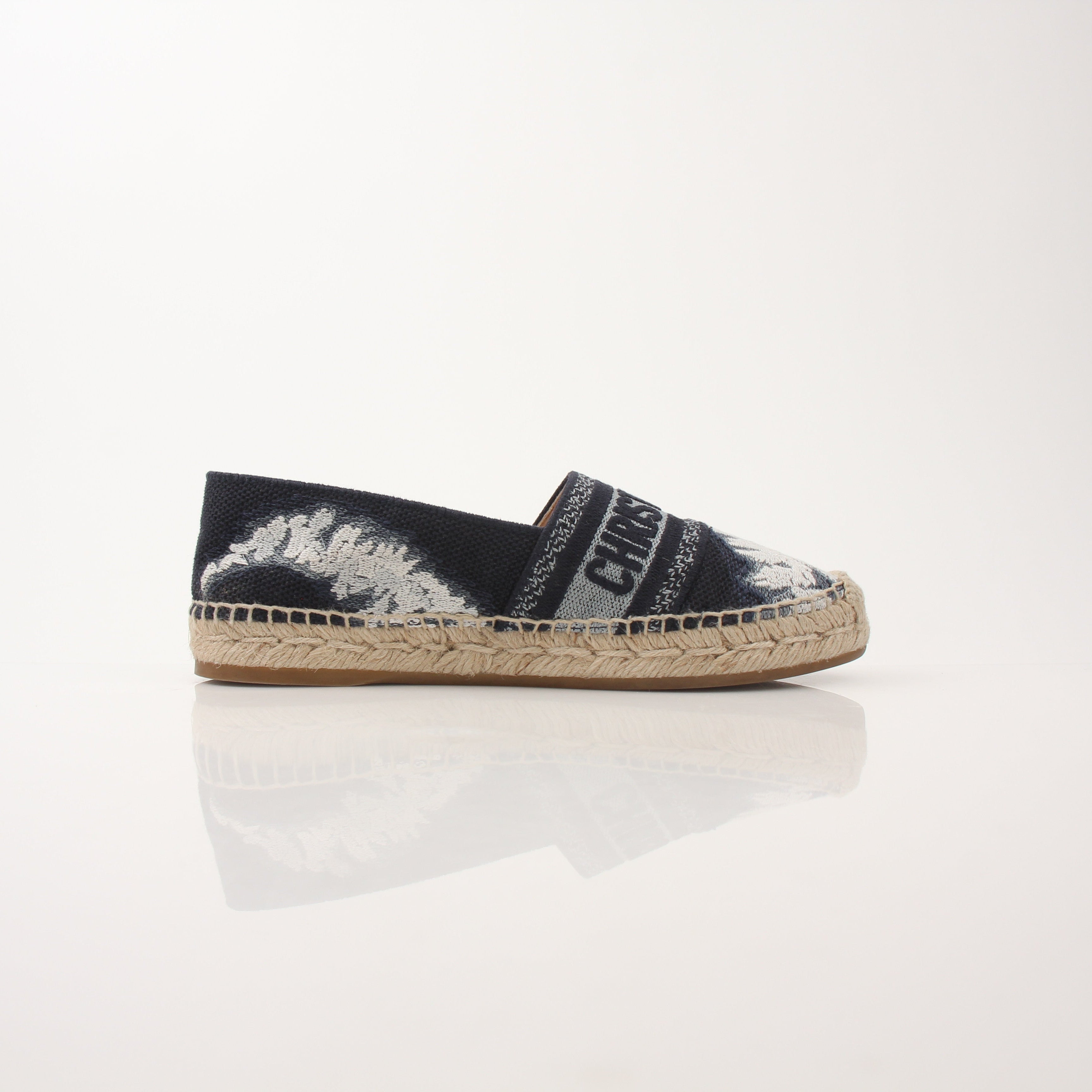 Christian Dior Women’s Granville Tie Dye Espadrille Flats shoes with woven fabric and rubber soles, featuring colorful tie dye pattern.