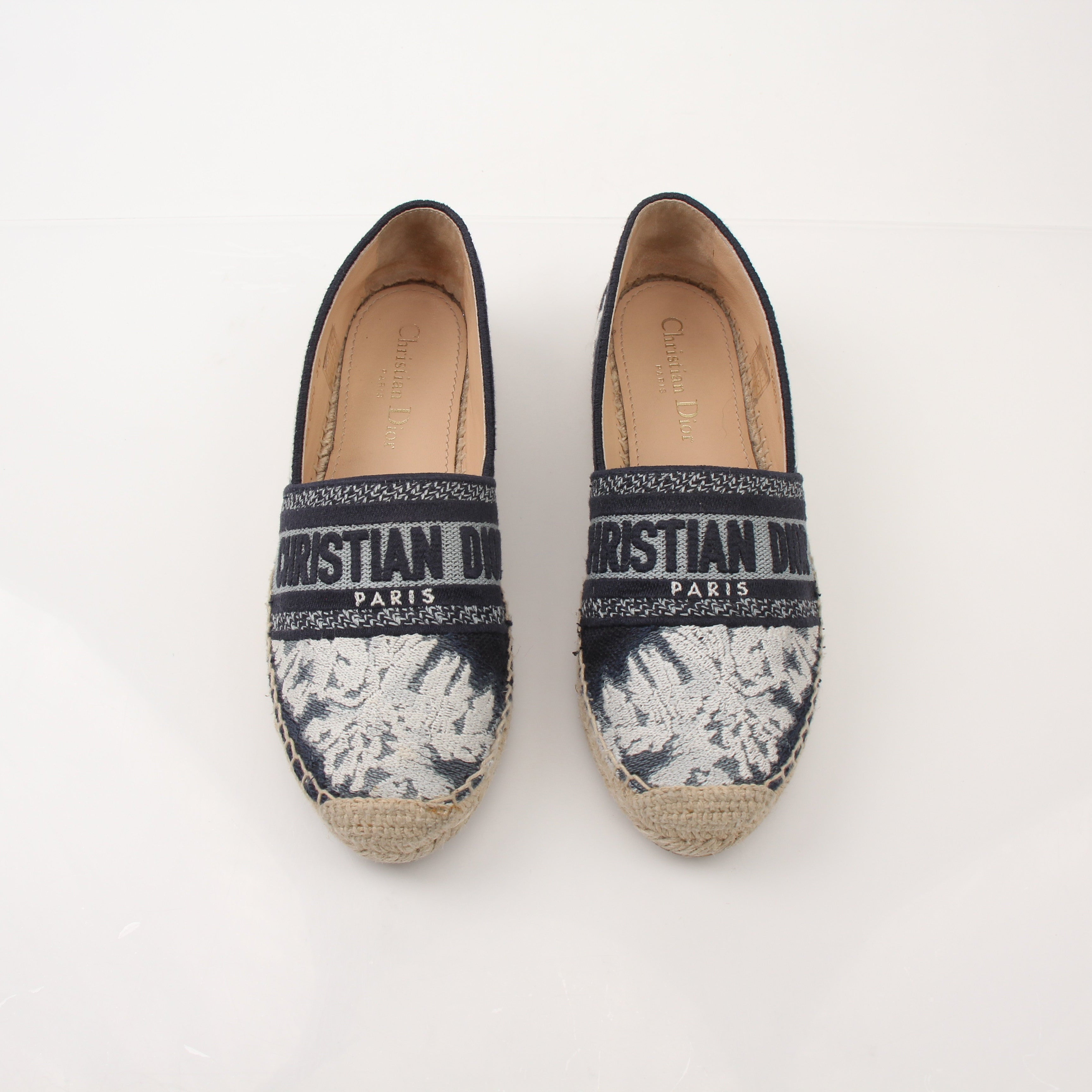 Christian Dior women’s Granville tie-dye espadrille flats with woven jute soles and colorful fabric uppers.