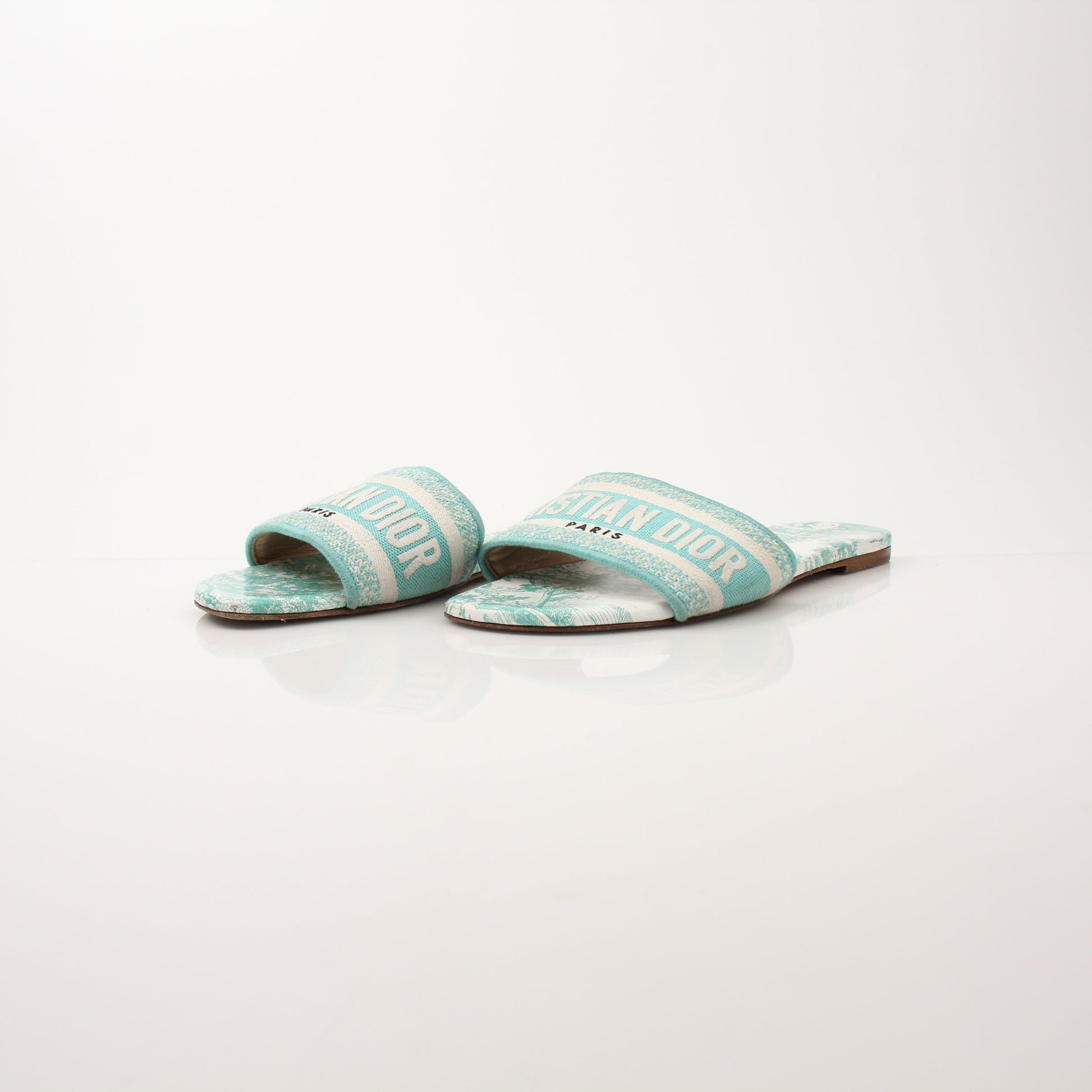 Christian Dior women's aquamarine D-Way slide sandals with streamlined design and slip-on style, featuring metallic finish.