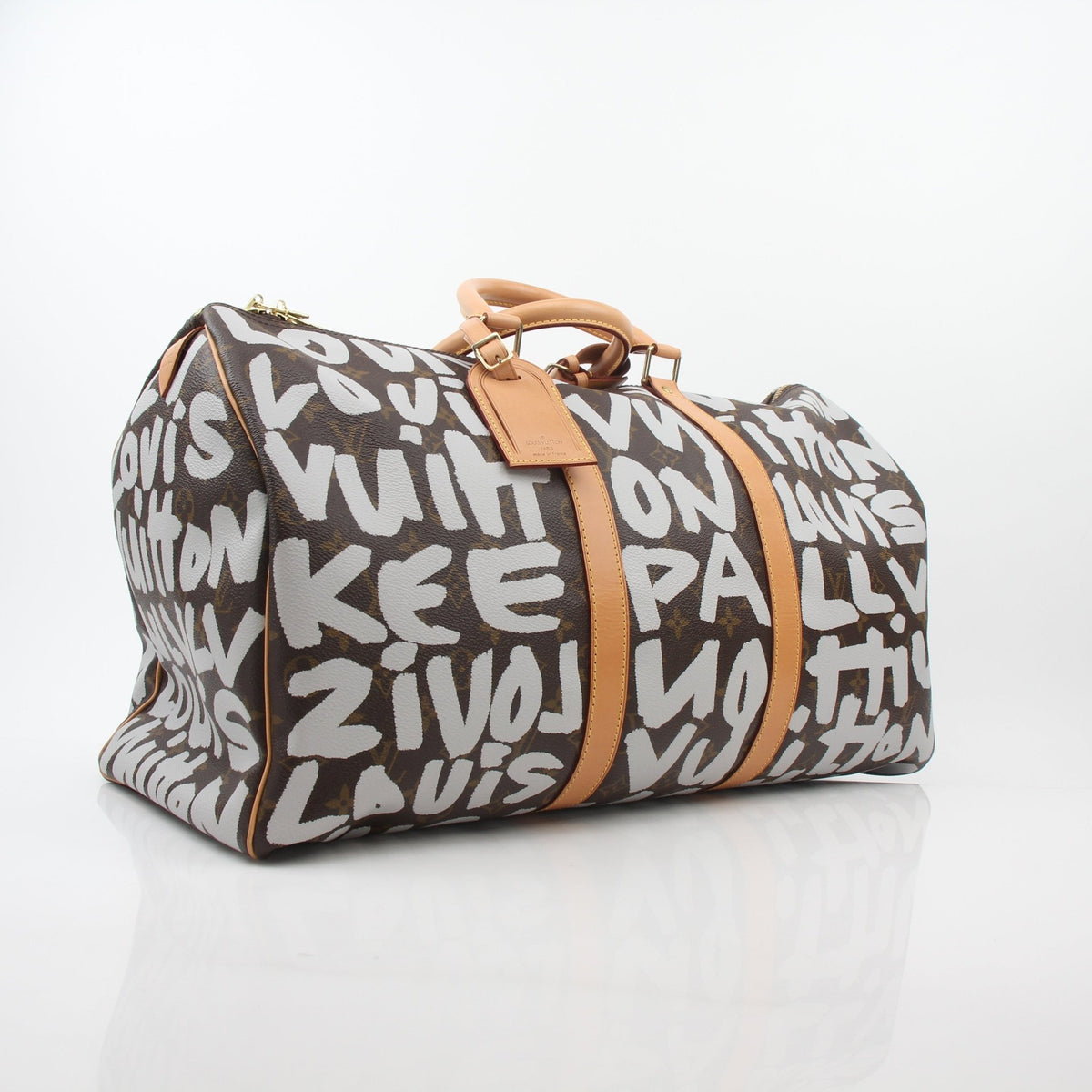 Louis Vuitton Brown Monogram Graffiti Keepall 50 travel bag with leather handles and gold-tone hardware, displayed on a neutral background.