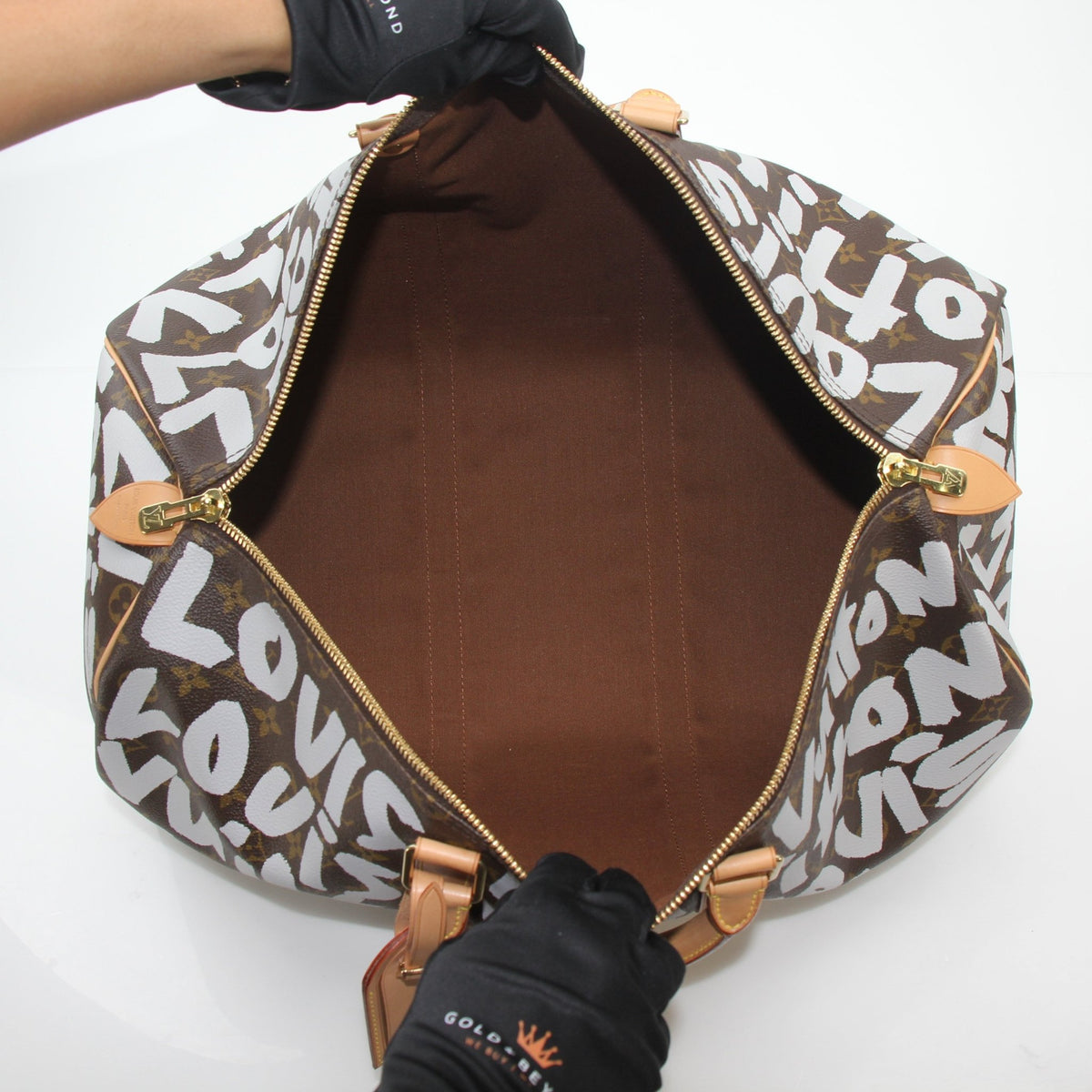 Louis Vuitton Brown Monogram Graffiti Keepall 50 travel bag with graffiti design, classic monogram pattern, and leather handles.