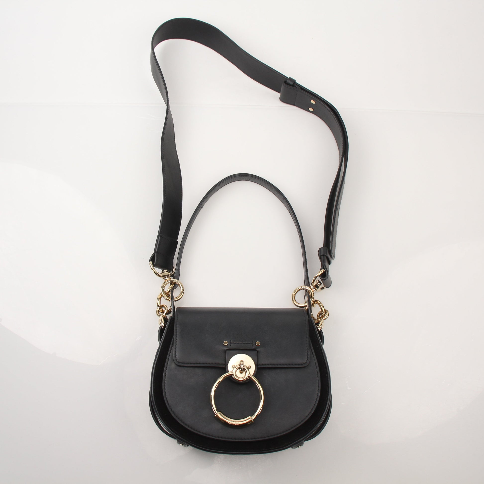 Gold & Beyond Chloé Tess Saddle Bag handbag with leather strap and gold hardware, featuring a classic saddle shape and brown color.