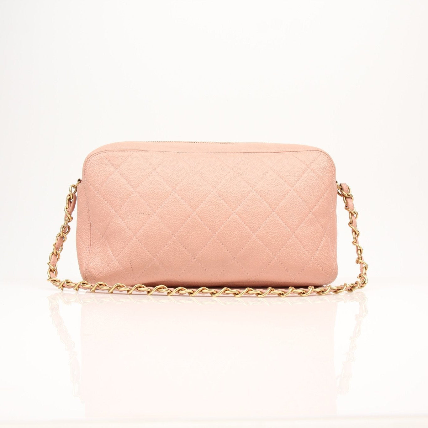 Pink Chanel Caviar Classic CC handbag with gold hardware, featuring textured leather and elegant design.