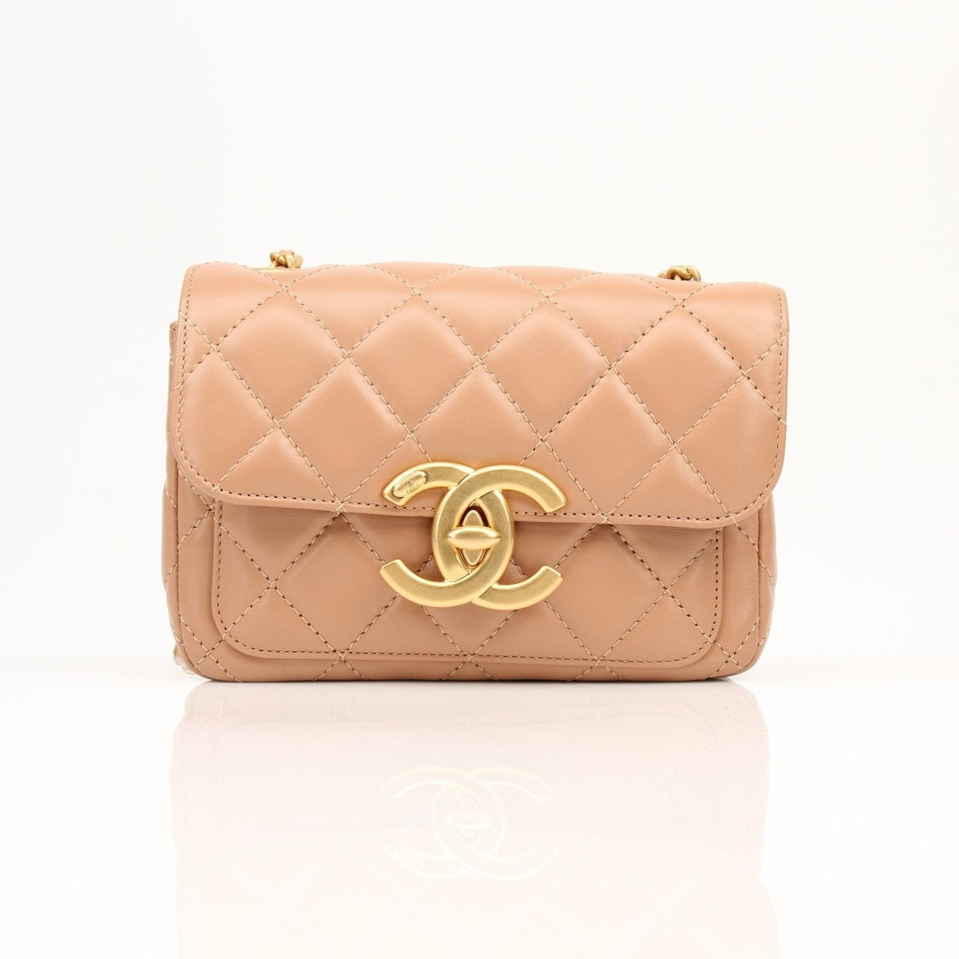 Gold & Beyond Chanel beige mini maxi handbag, stylish and compact with gold hardware, perfect for elegant everyday carry.