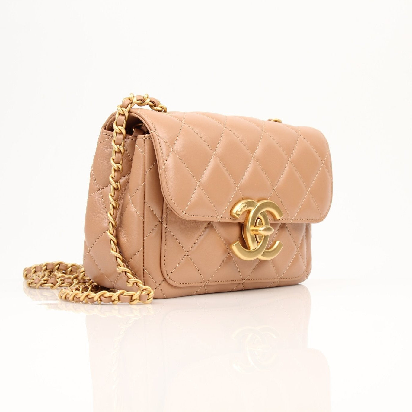 Gold & Beyond Chanel beige mini maxi handbag with gold hardware, featuring a sleek, compact design perfect for stylish occasions.