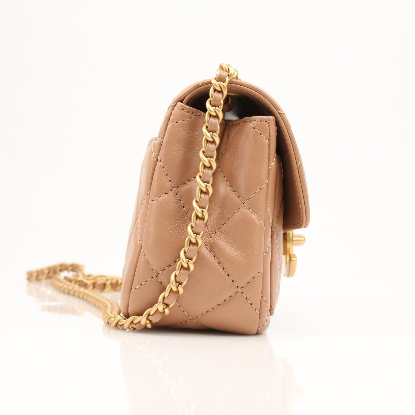 Gold & Beyond beige mini maxi handbag featuring a compact design and stylish handle, perfect for casual and elegant outfits.