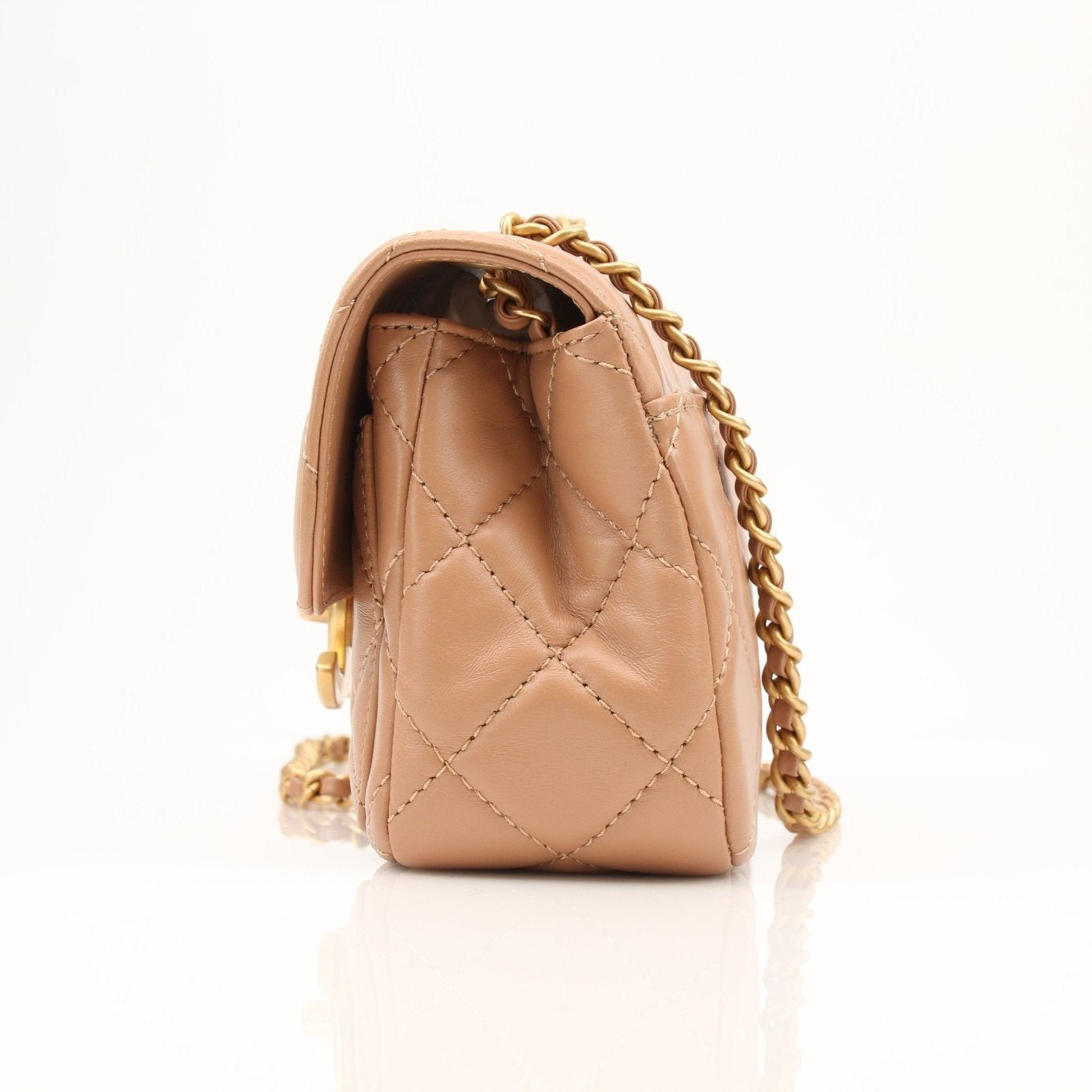 Gold & Beyond Chanel beige mini maxi handbag with top handles and gold hardware, stylish and compact for everyday use.