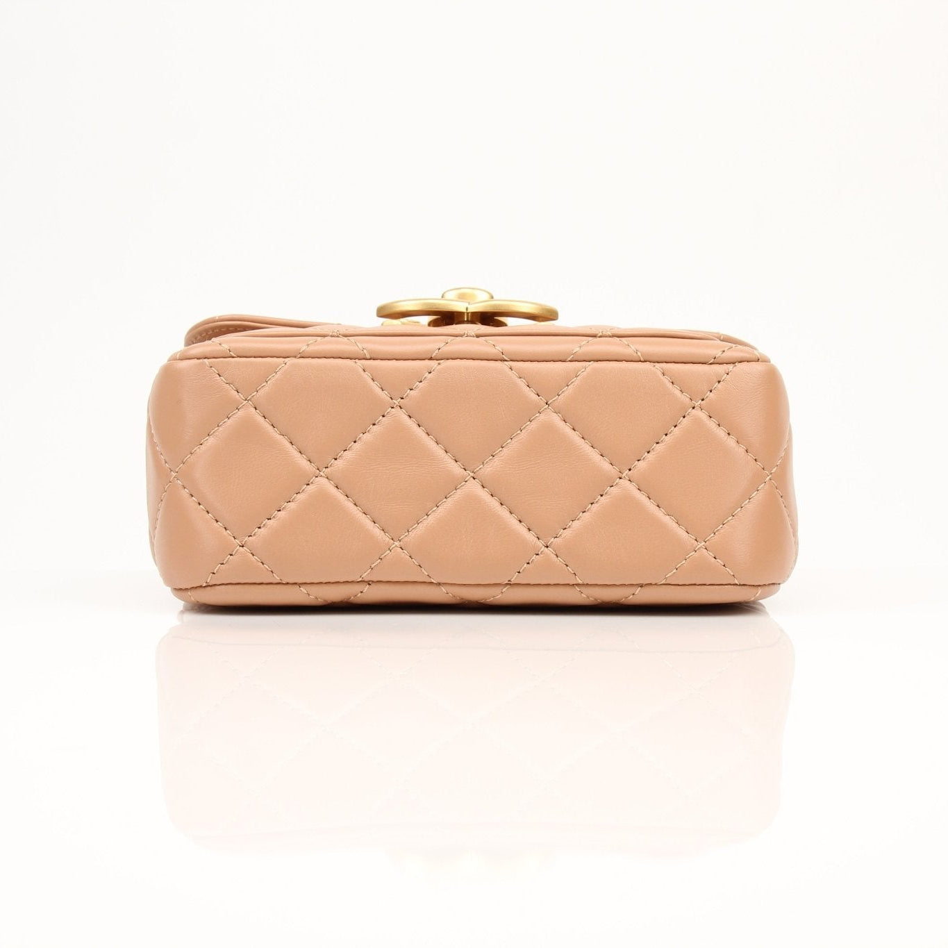 Gold & Beyond Chanel beige mini maxi handbag with gold hardware and structured design, shown in the image.