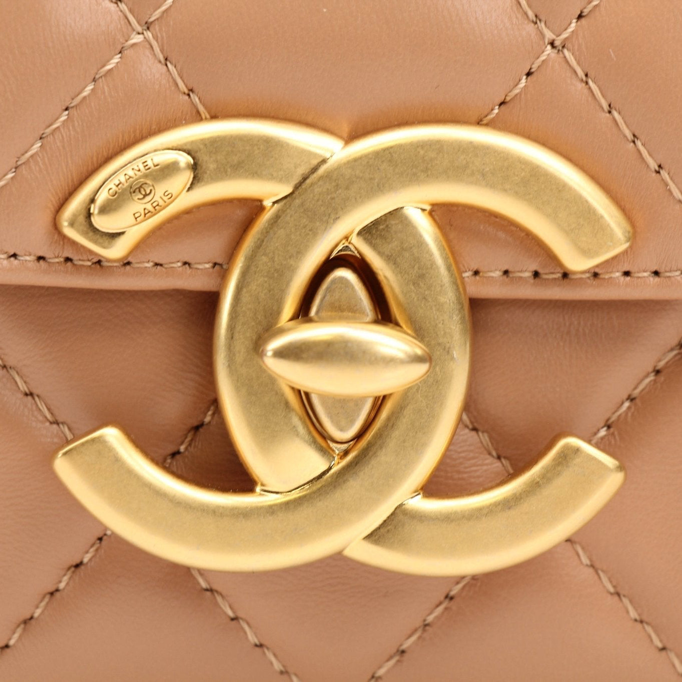 Gold & Beyond Chanel beige mini maxi handbag with gold hardware and chain strap, stylish and compact leather hand-held bag.