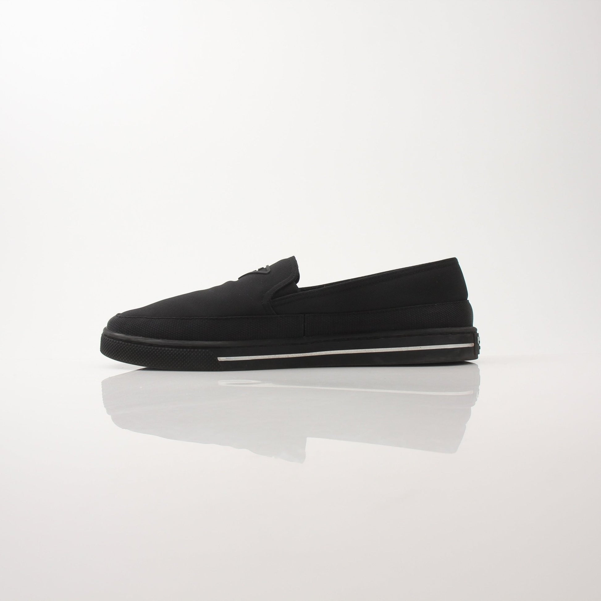 Prada men's triangle logo nylon slip-on loafers featuring sleek design and durable nylon material, ideal for stylish casual wear.