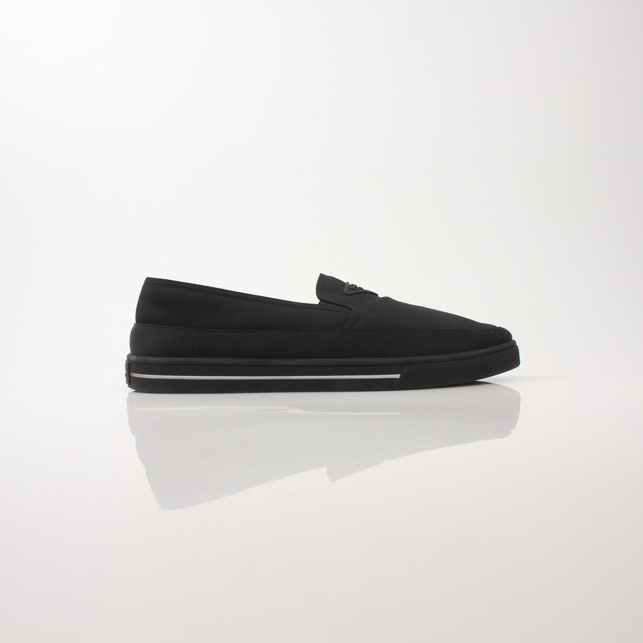 Prada men's triangle logo nylon slip-on loafers with sleek design and comfortable fit, featuring iconic logo detail.