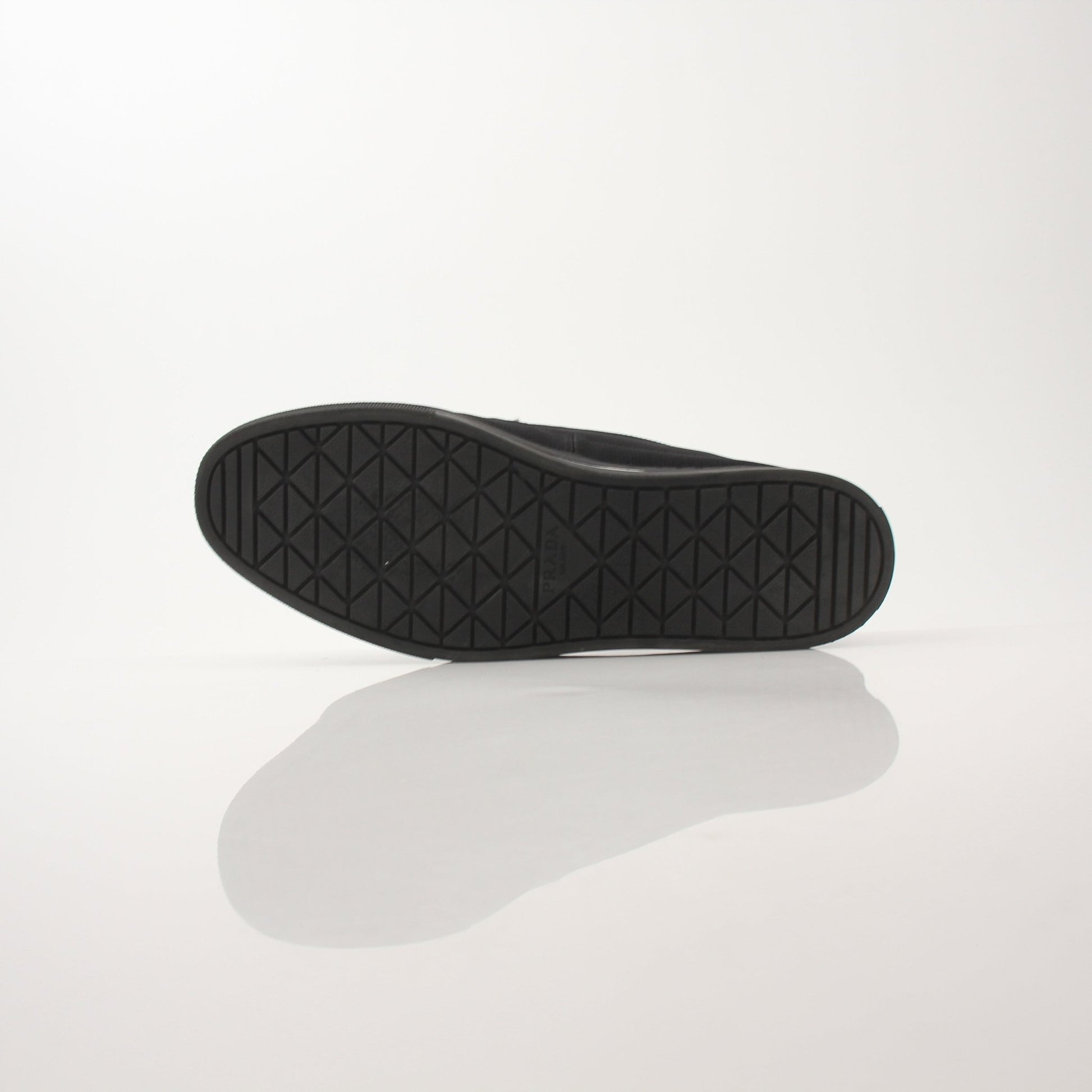 Prada men's triangle logo nylon slip-on loafers with sleek design and comfortable slip-on style.