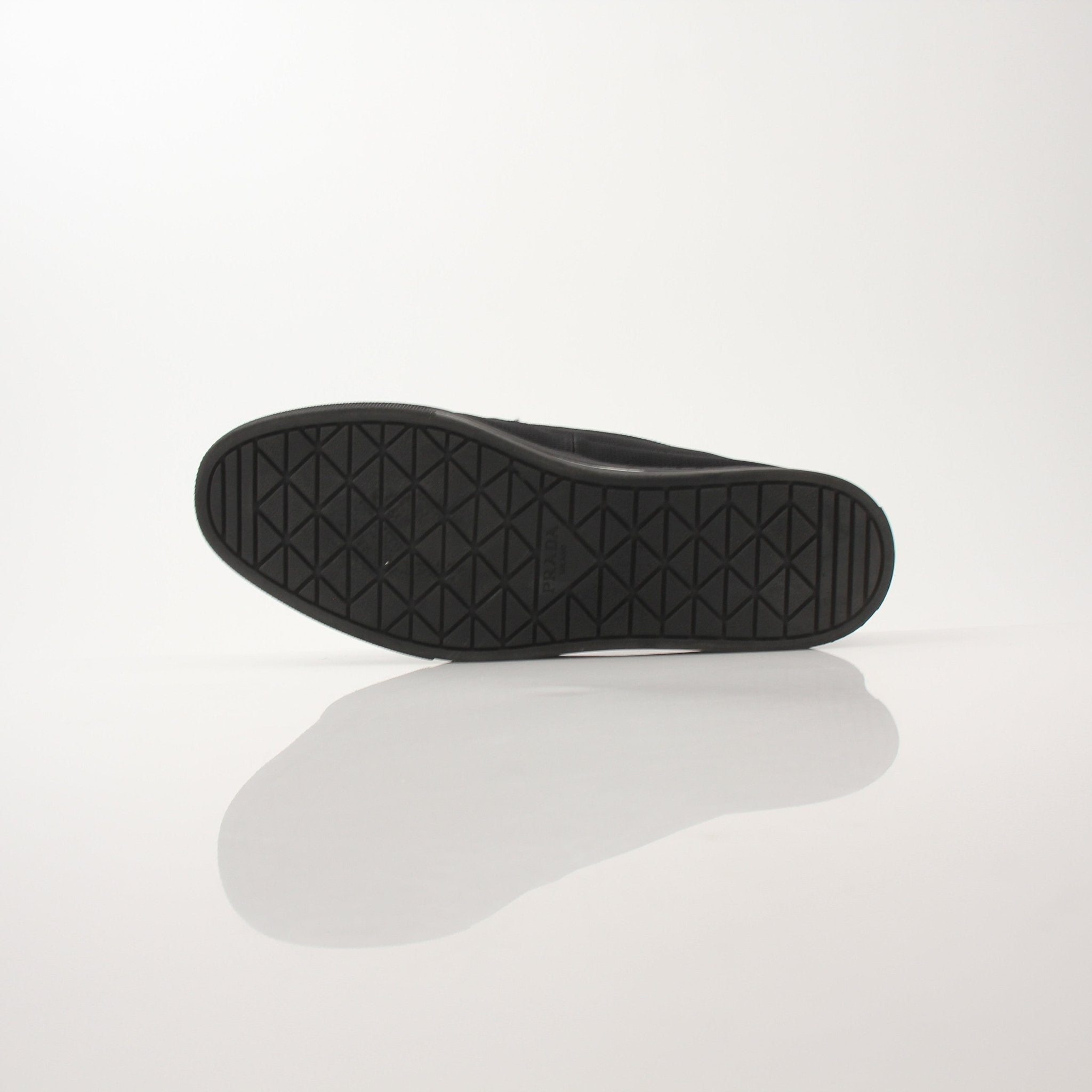 Prada men's triangle logo nylon slip-on loafers with sleek design and comfortable slip-on style.