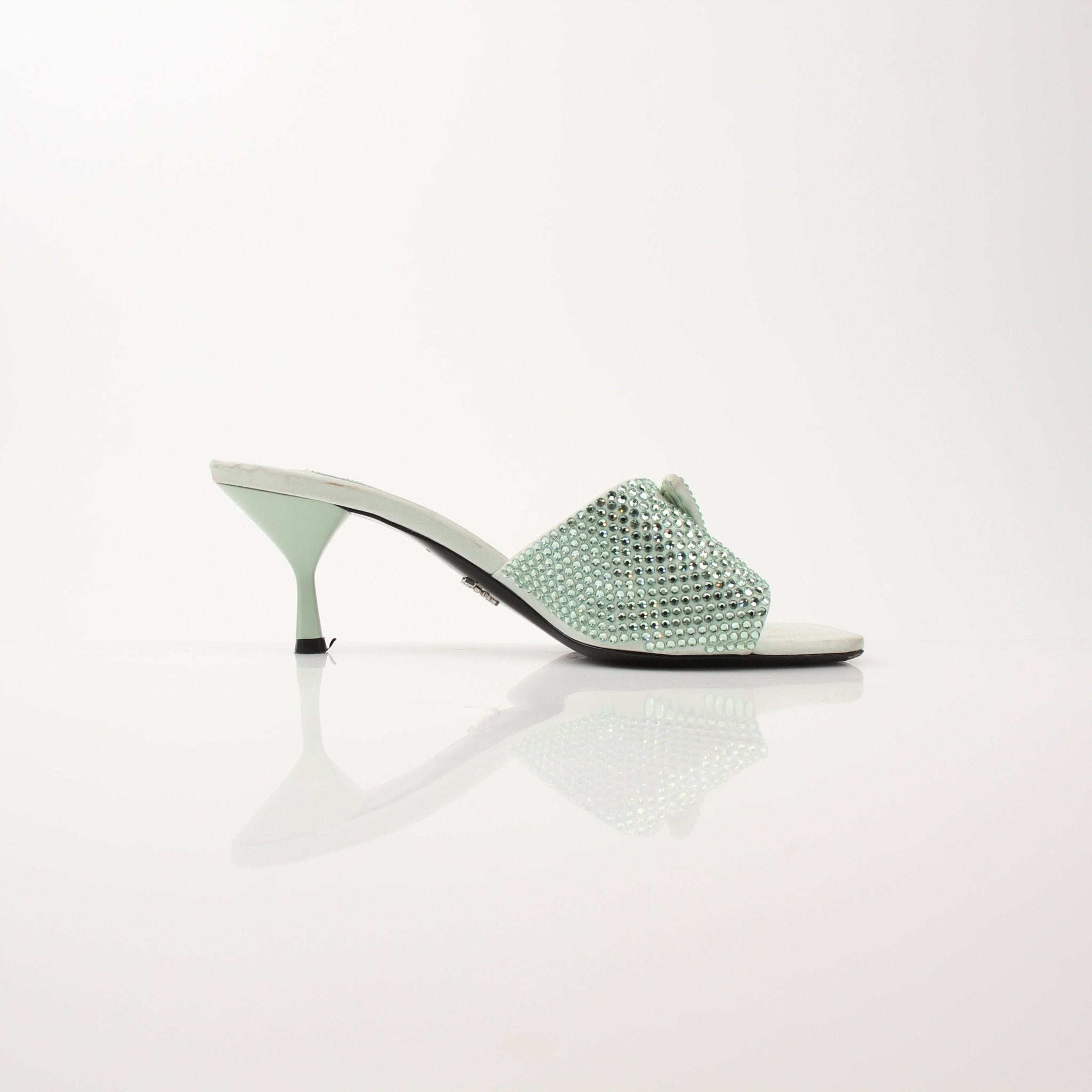 Prada women's crystal-embellished open-toe mules with gold-tone heels, featuring elegant strap design and sparkling crystal details.