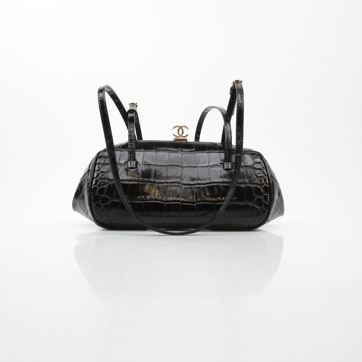 Black Chanel Pretty CC croc-embossed barrel handbag with gold accents and structured design, featuring the iconic CC logo.