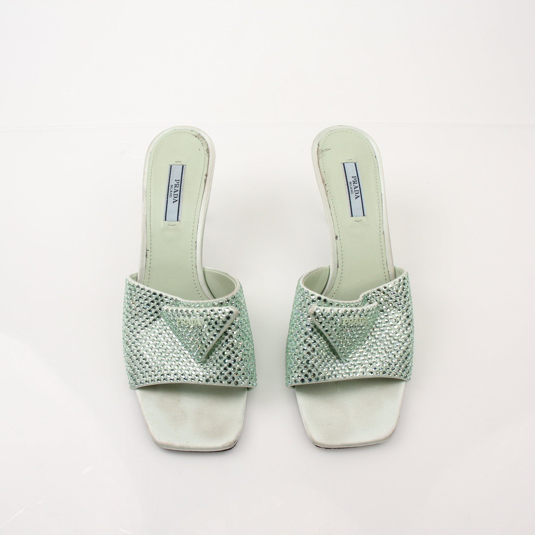 Prada women's crystal-embellished open-toe mules, luxury heels with sparkling details and elegant design, on a neutral background.