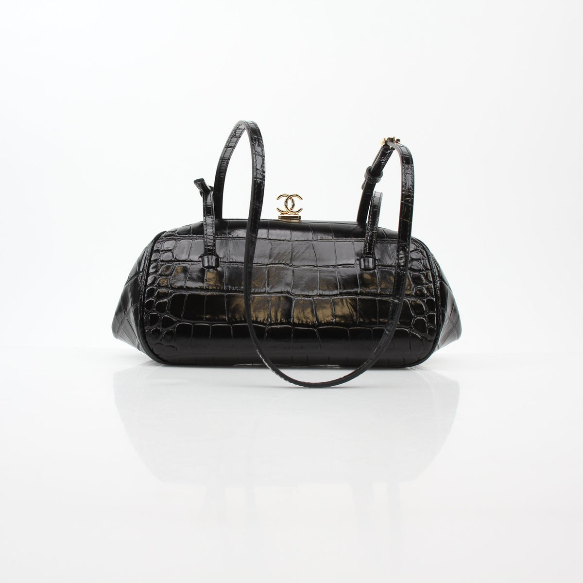 Chanel black croc-embossed barrel handbag with Pretty CC logo, stylish handbag accessory, gold hardware accents.