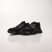Prada Men’s Cloudbust Thunder knit fabric sneakers in black with white accents, featuring a modern athletic shoe design.