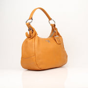 Prada orange Daino leather handbag with sleek design and top handle, showcasing luxurious craftsmanship and vibrant color.