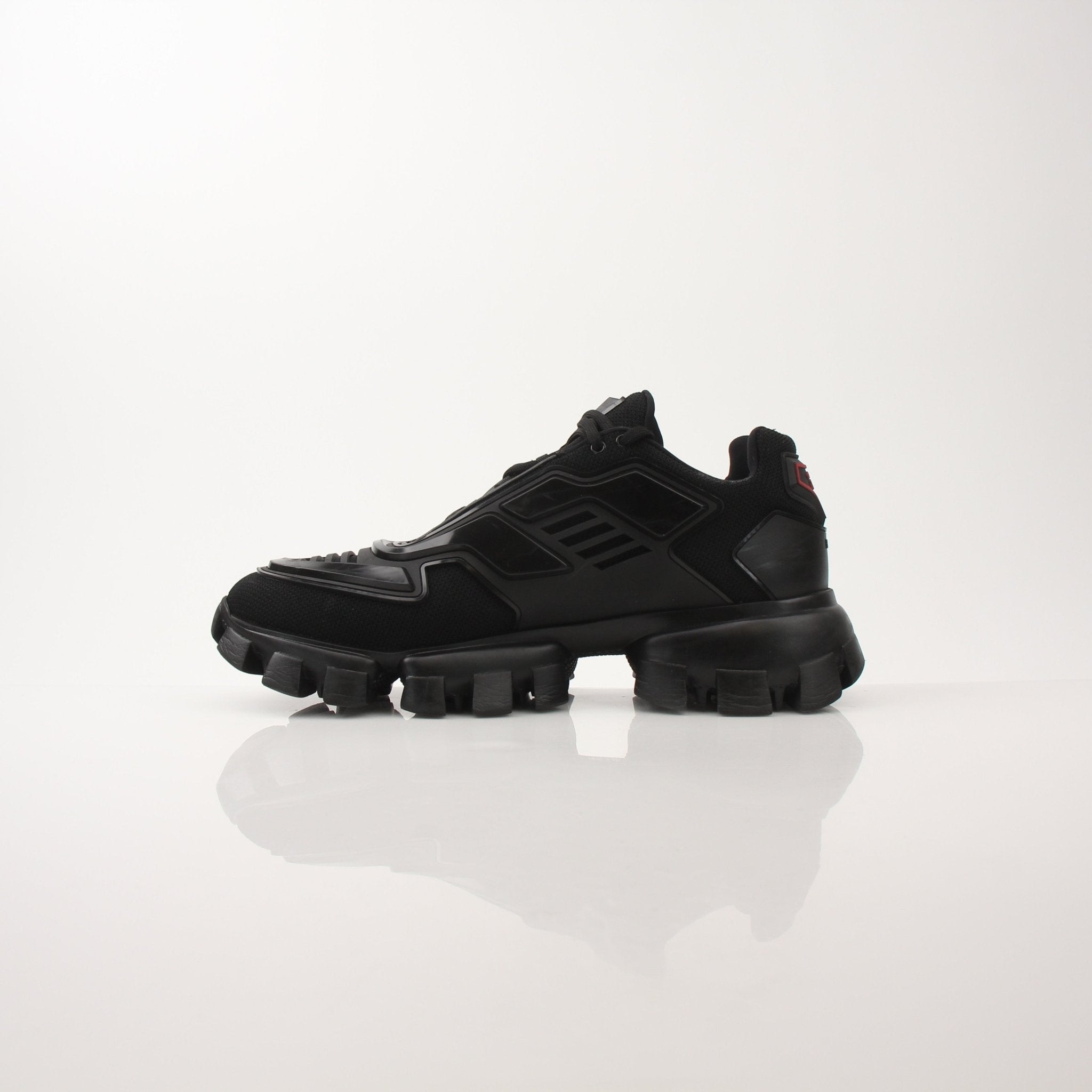 Prada Men’s Cloudbust Thunder knit fabric sneakers with sleek design and white sole, displayed on a plain background.