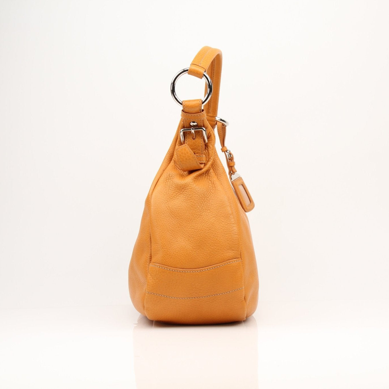 Prada orange Daino leather handbag with sleek design and top handle, showcasing luxurious craftsmanship and vibrant color.