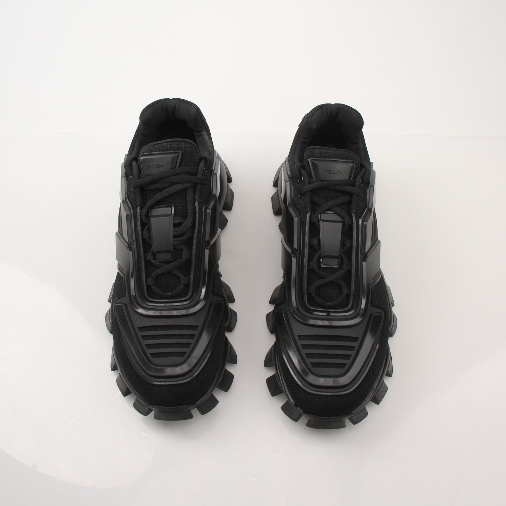 Prada Men’s Cloudbust Thunder knit fabric sneakers in black with white soles, showcasing sporty design and branded details.