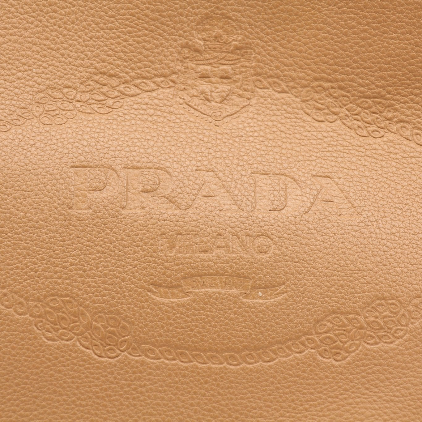 Prada Phenix bucket handbag with leather construction and metal hardware, featuring a stylish and spacious design.