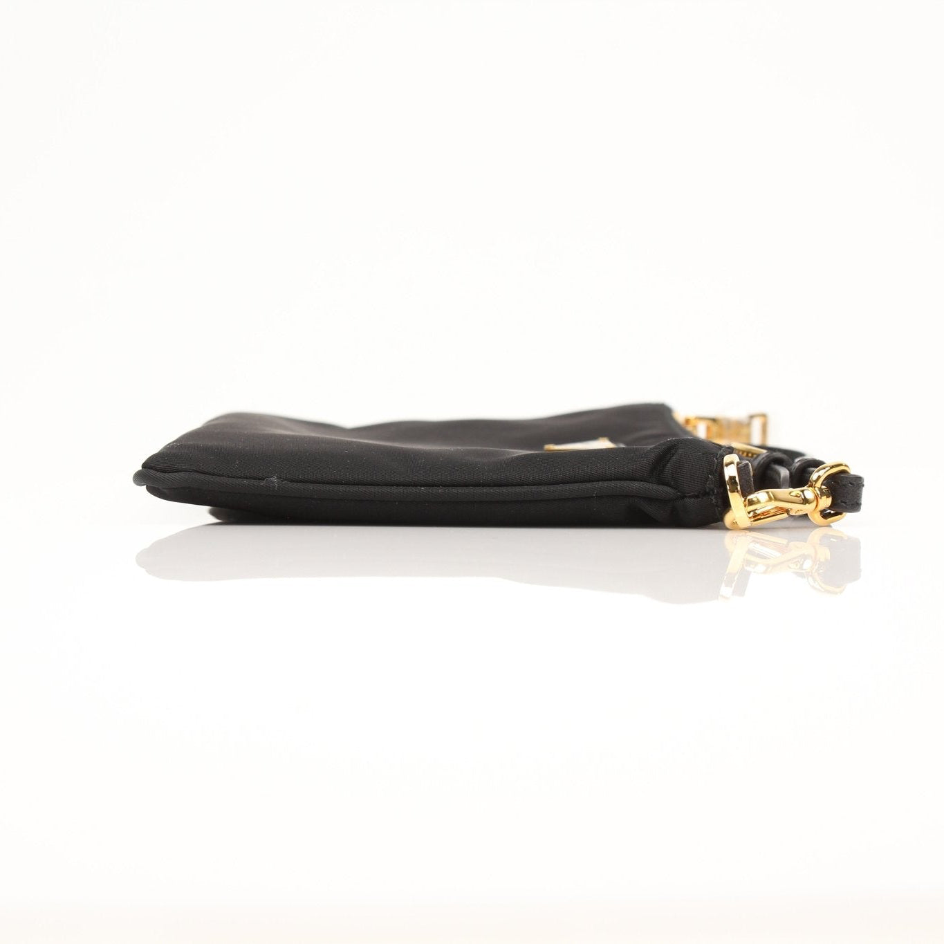 Prada black Re-Nylon wristlet with sleek design and zipper closure, featuring the Prada logo on the front.