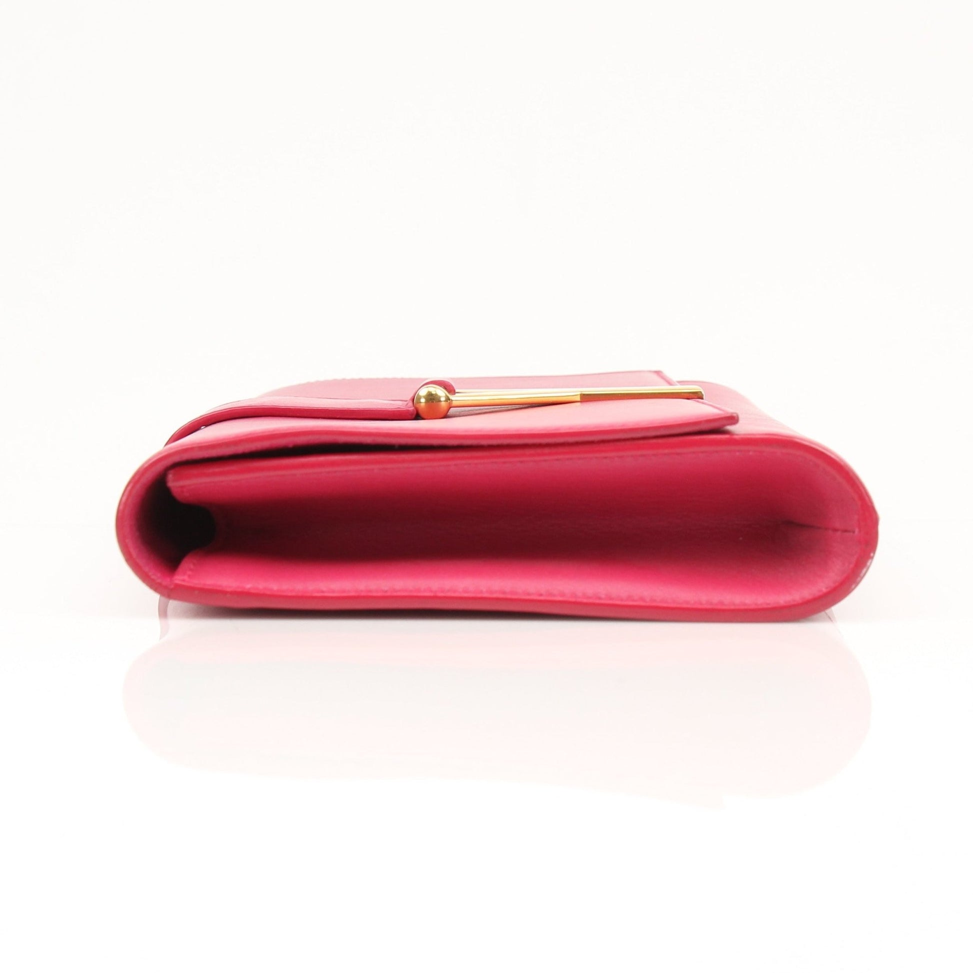Gold & Beyond Yves Saint Laurent Chyc leather clutch handbag with sleek design and gold accents.