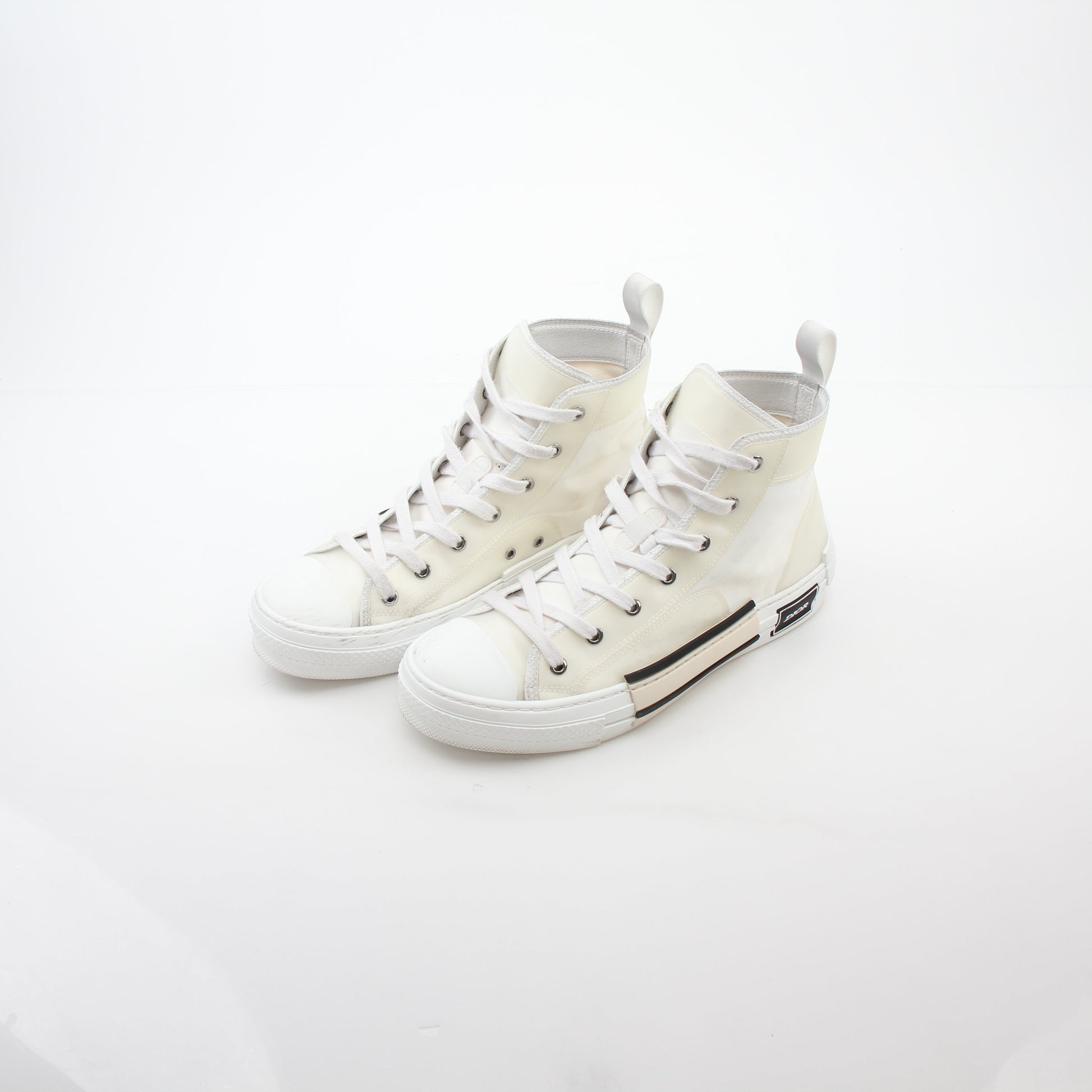 Christian Dior White B23 high-top sneakers with gold accents, showcasing the stylish shoe design and branding details.