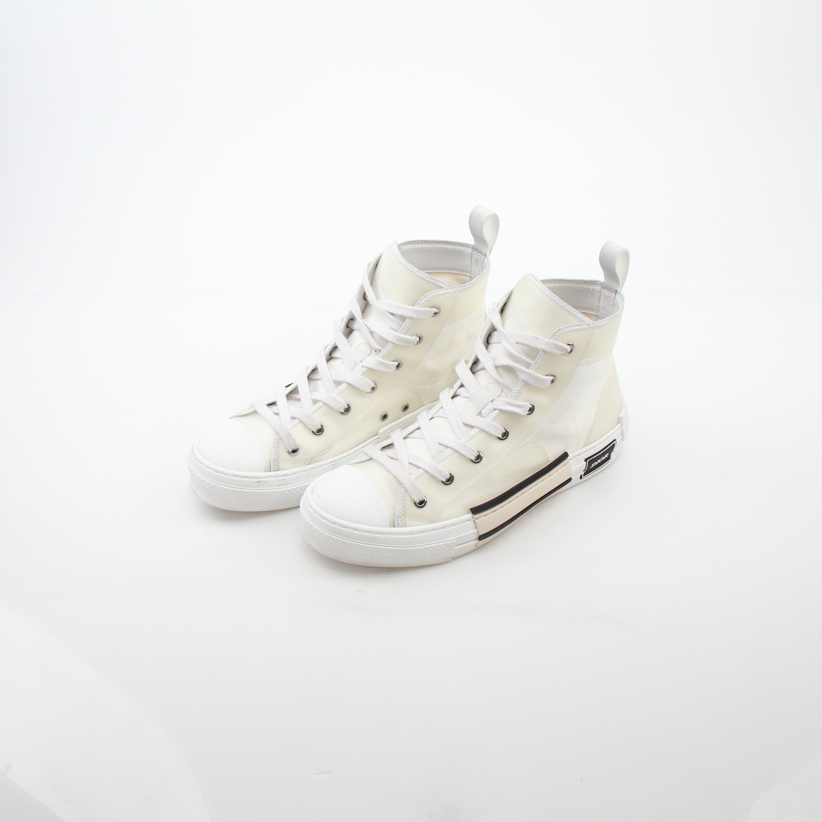 Christian Dior White B23 high-top sneakers with gold accents, showcasing the stylish shoe design and branding details.